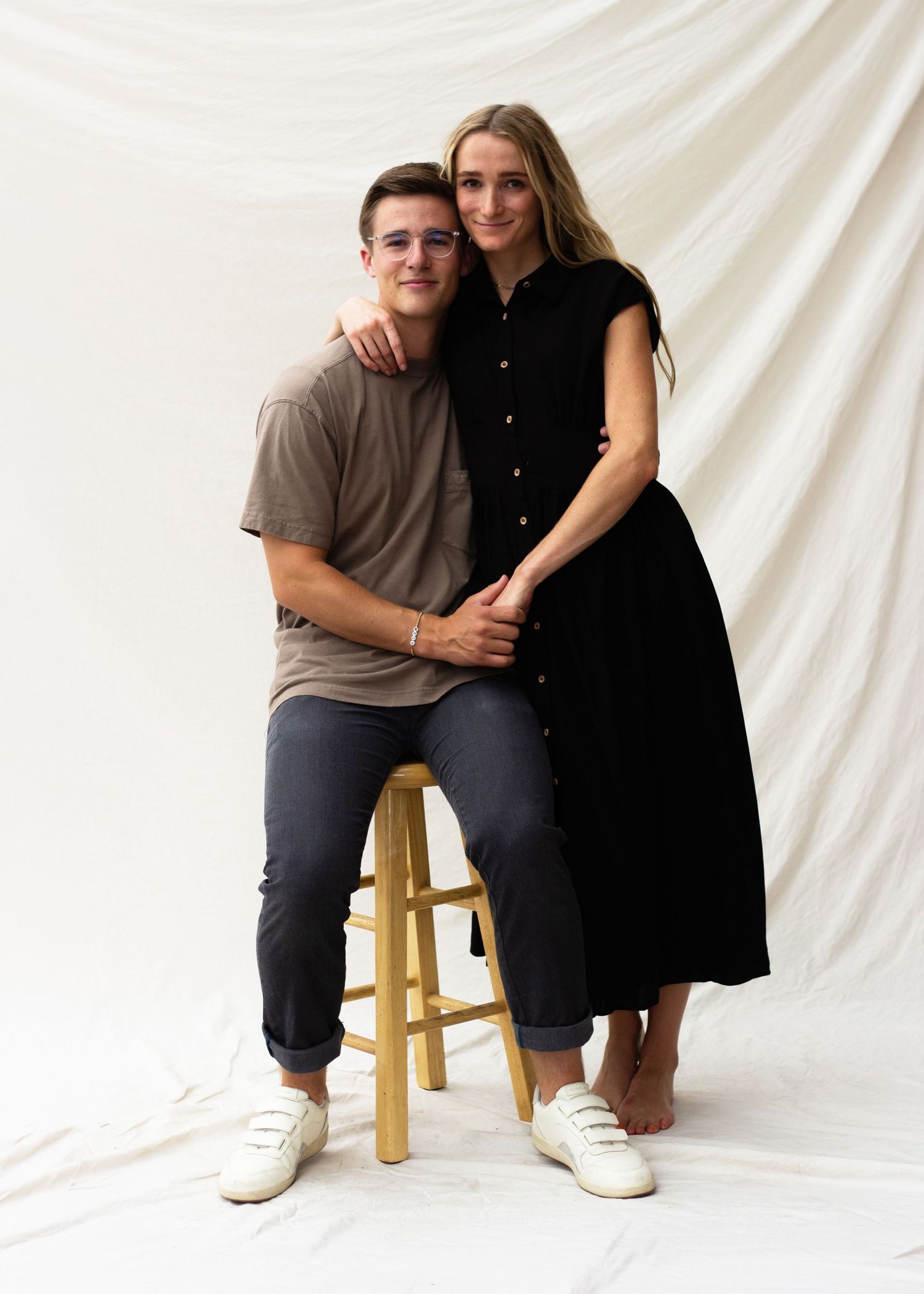 Classic studio couple's portrait. Minimalist white backdrop with professional lighting. High-end imagery for lifestyle & family portfolios.