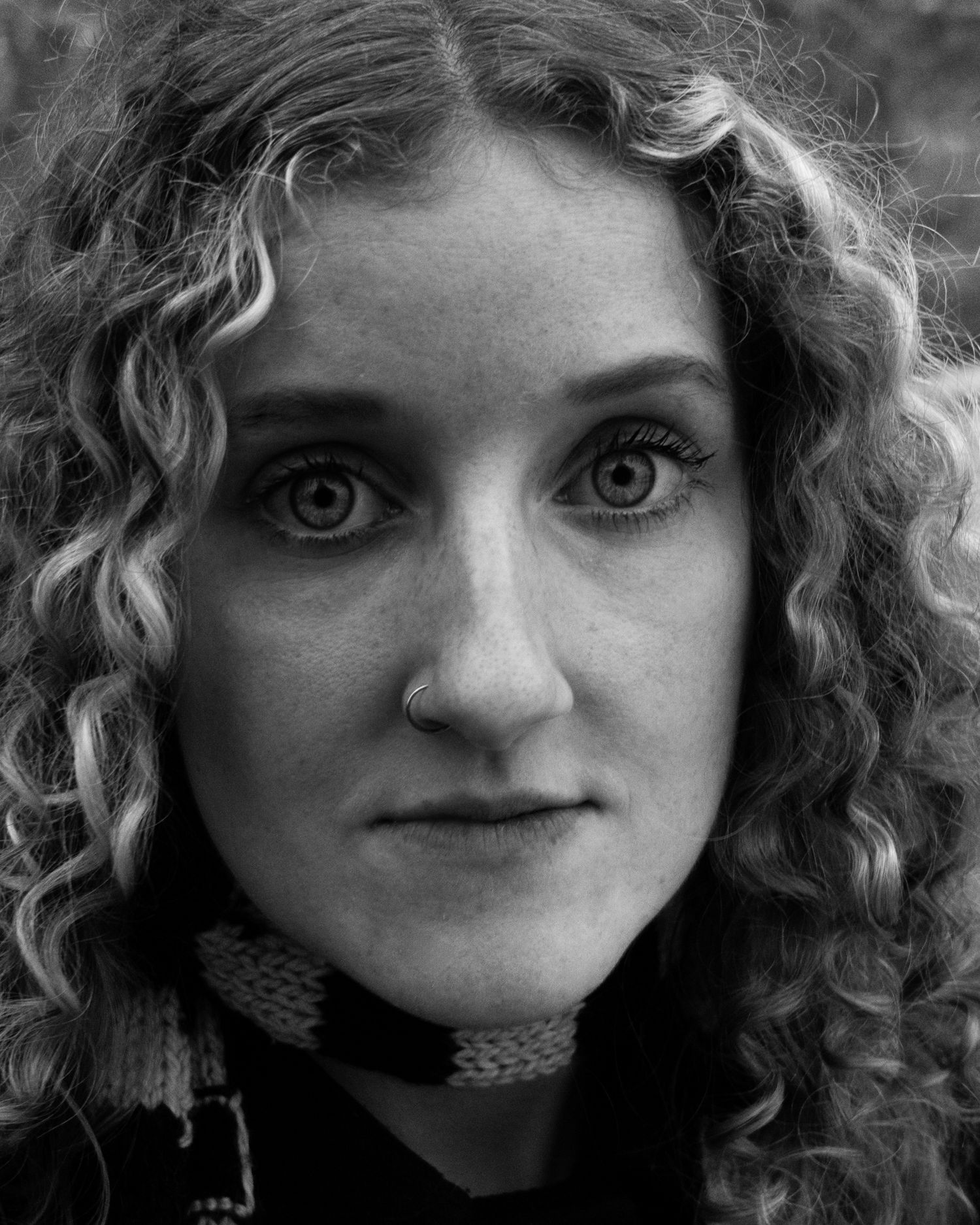 Striking monochrome female portrait. Dramatic close-up with professional lighting. Premium imagery for editorial features and artist bios.
