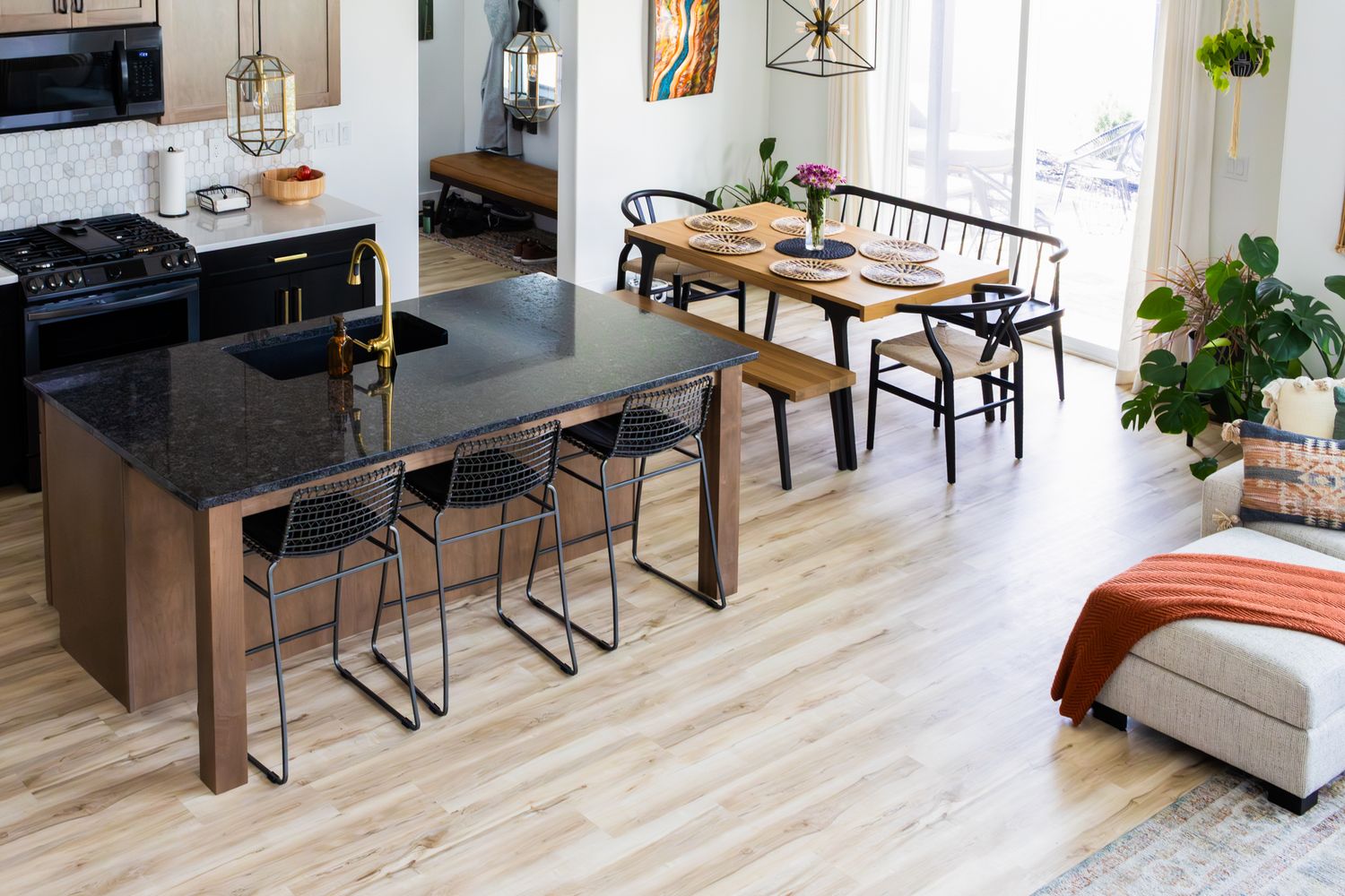 High-angle professional interior photography of a modern open-concept kitchen and dining area, featuring sleek finishes and bright natural