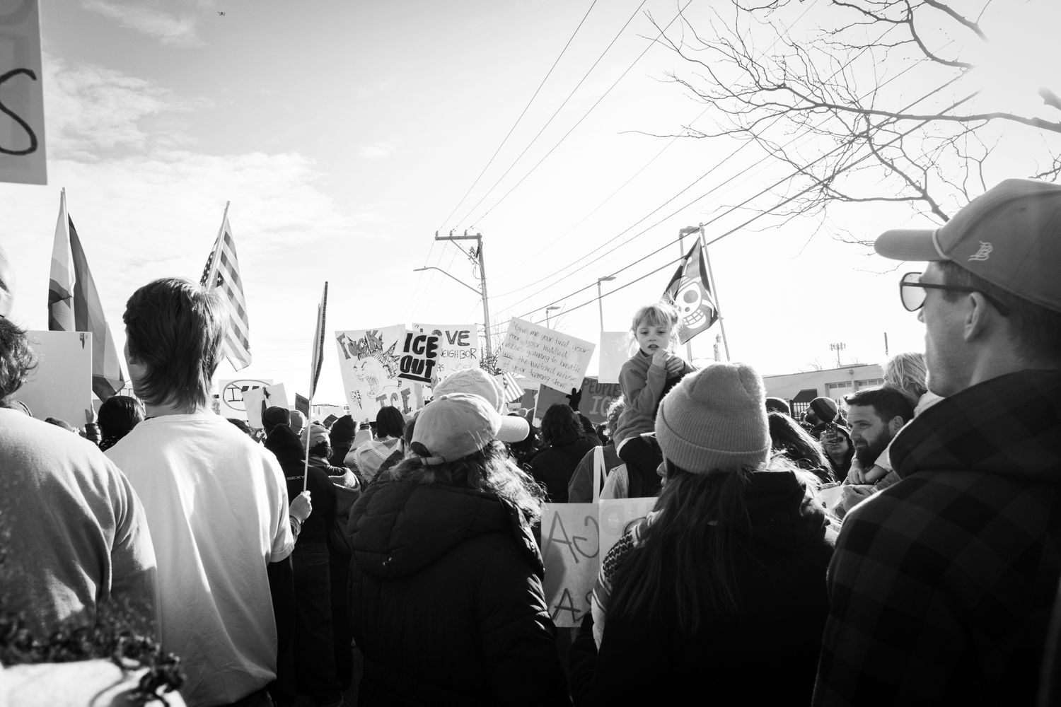 Powerful B&W documentary photography. Large crowd and flags at a city protest. Authentic wide-angle imagery for news and editorial use.