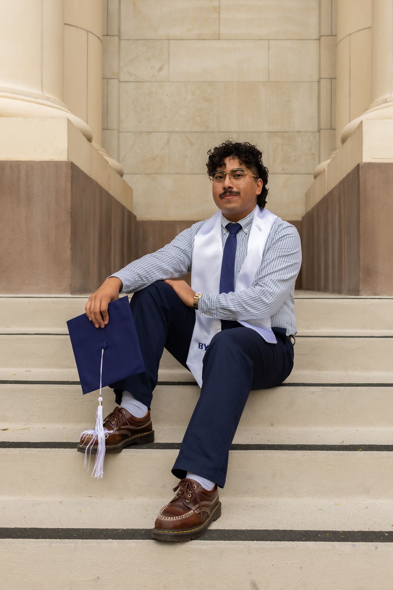 Authentic university grad photo and portrait. High-quality campus session with professional posing. Commemorate your achievement with style.