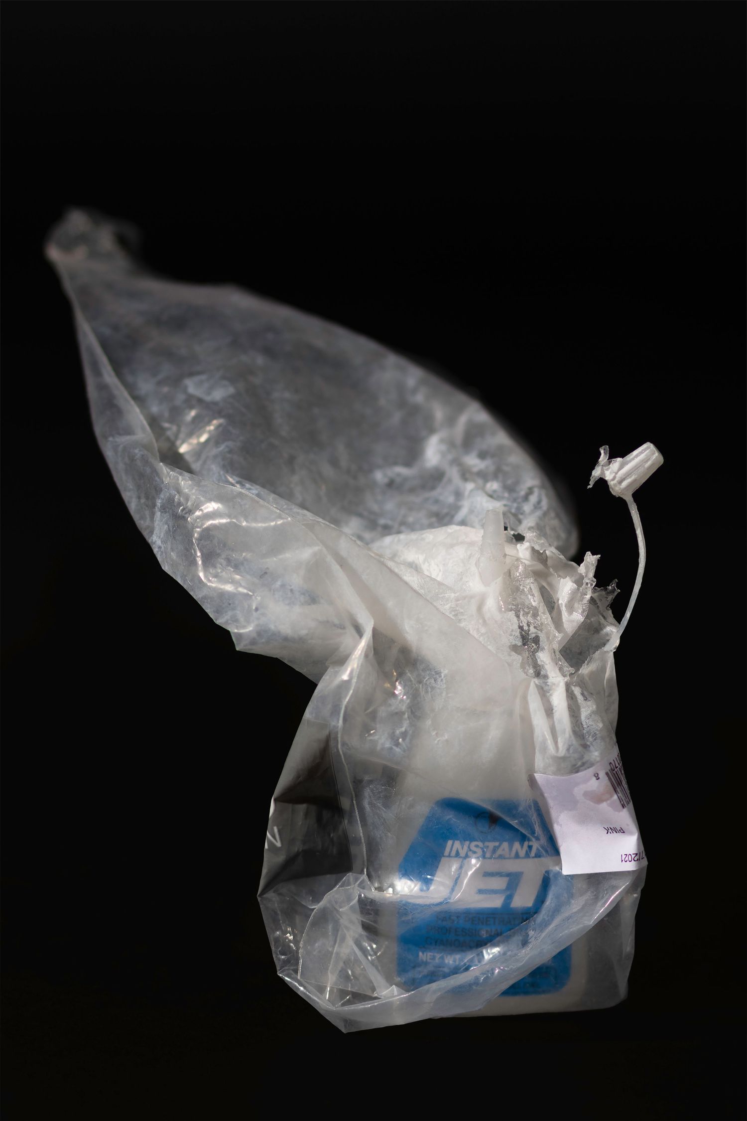 High-contrast study of waste and packaging. Professional product shot of discarded plastic. Visual commentary for environmental features.