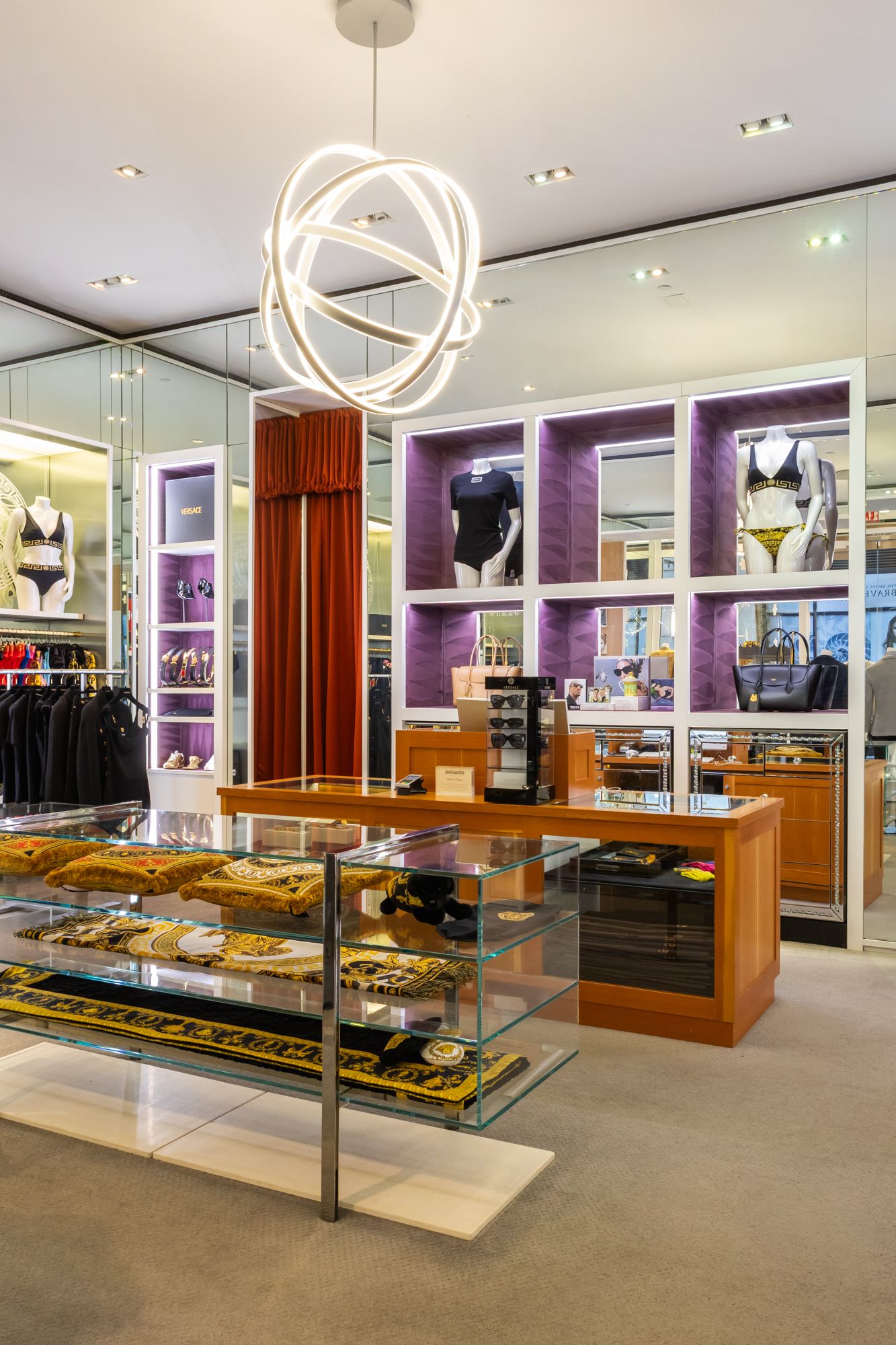Luxury boutique interior photography. Modern orb lighting and high-end apparel displays. Professional imagery for retail design portfolios.