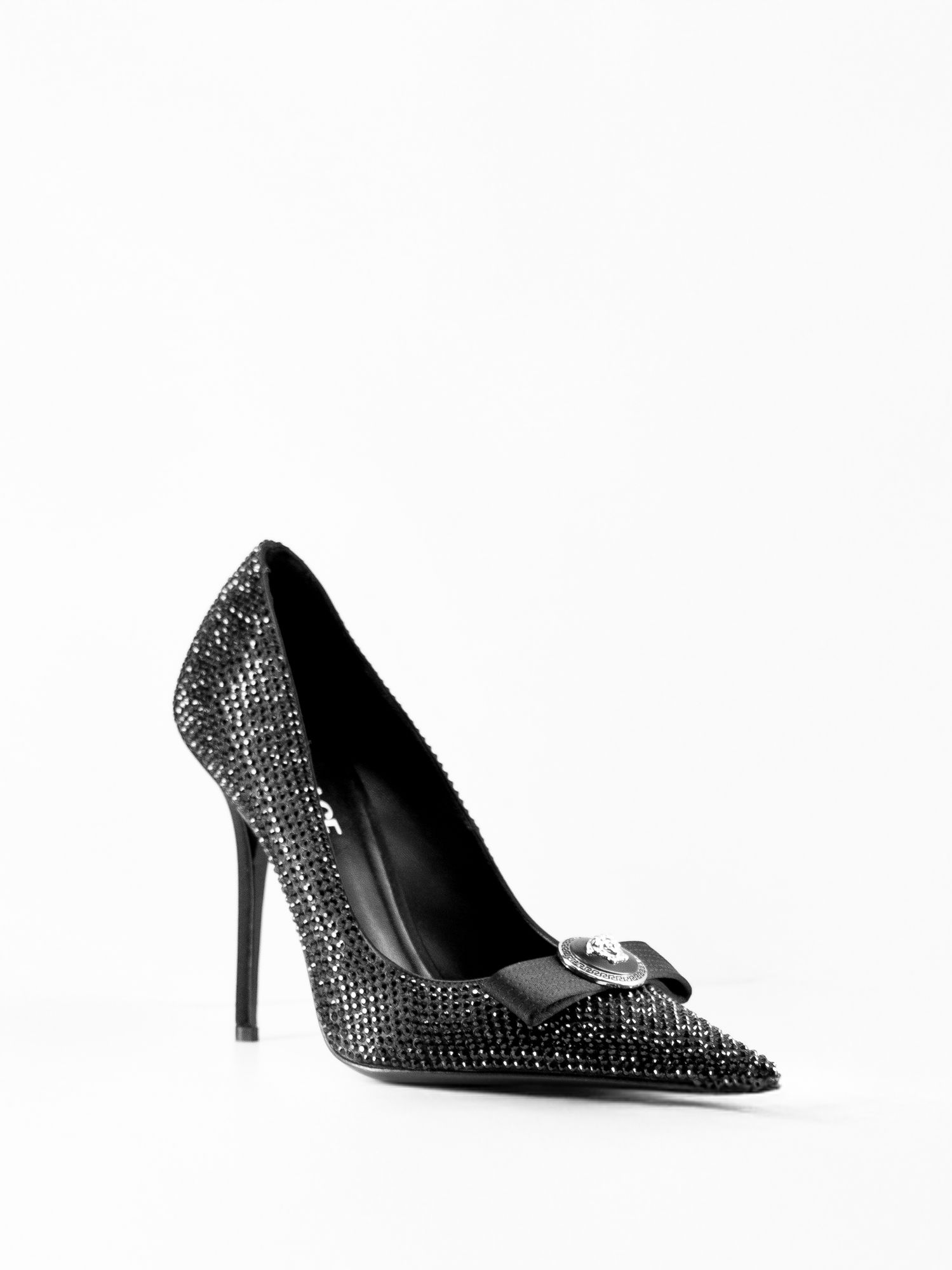 High-key luxury product photography of a black crystal Versace pump, featuring sharp focus and professional lighting for premium e-commerce.