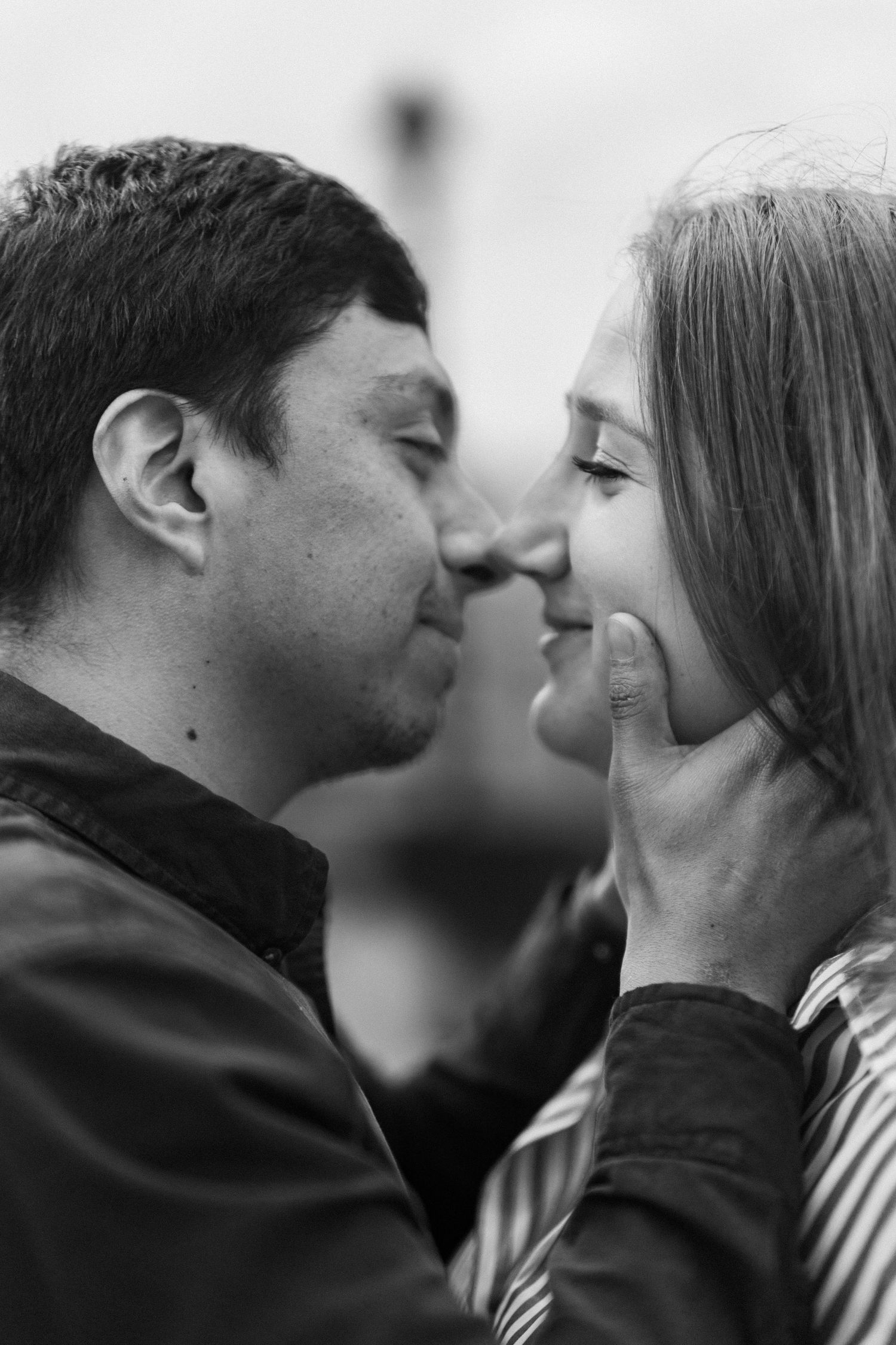 An intimate black and white portrait of a couple sharing a tender moment together.