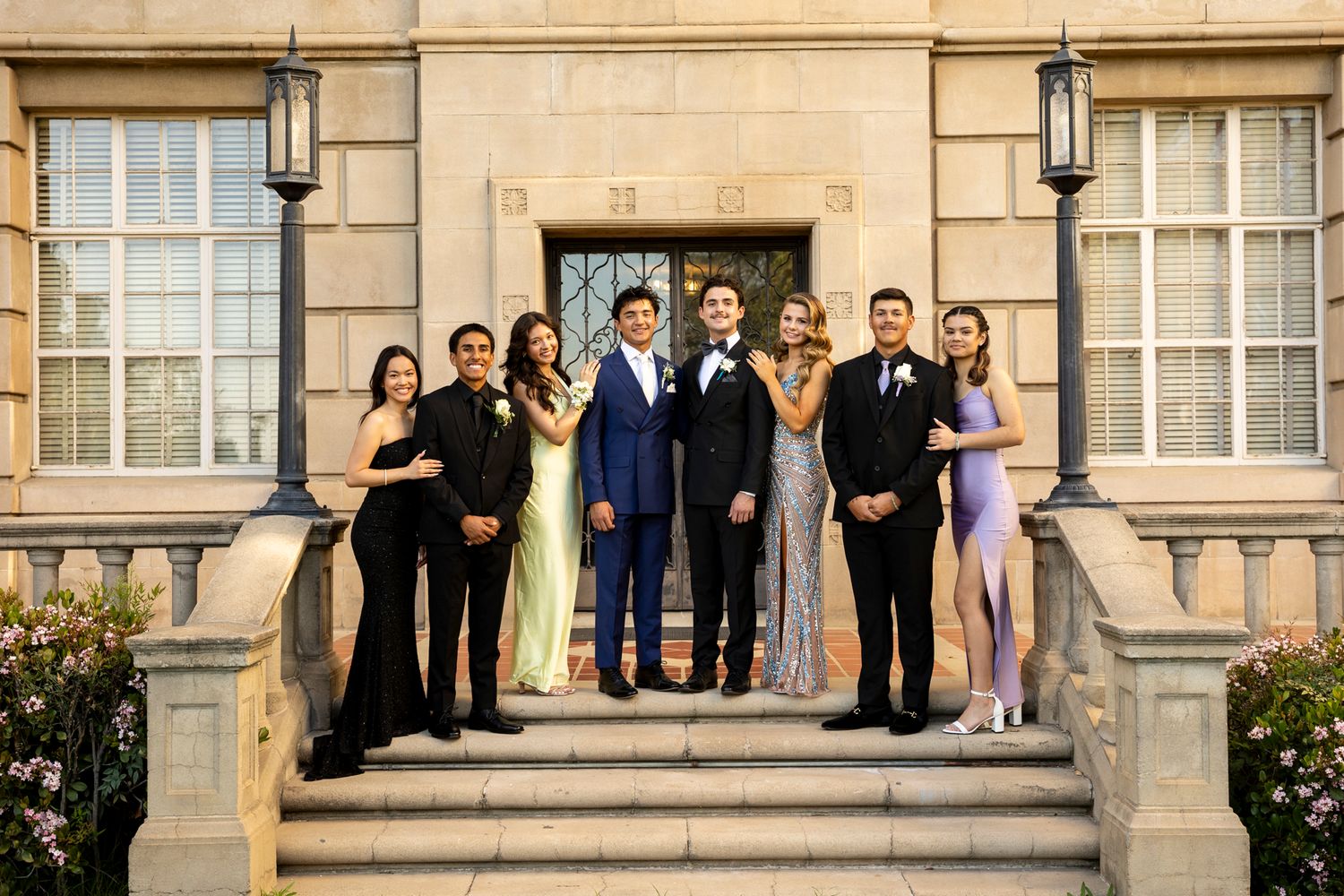 Prom Portraits in formal attire standing on Univeristy of Redlands stone building steps.  Riverside Photographer