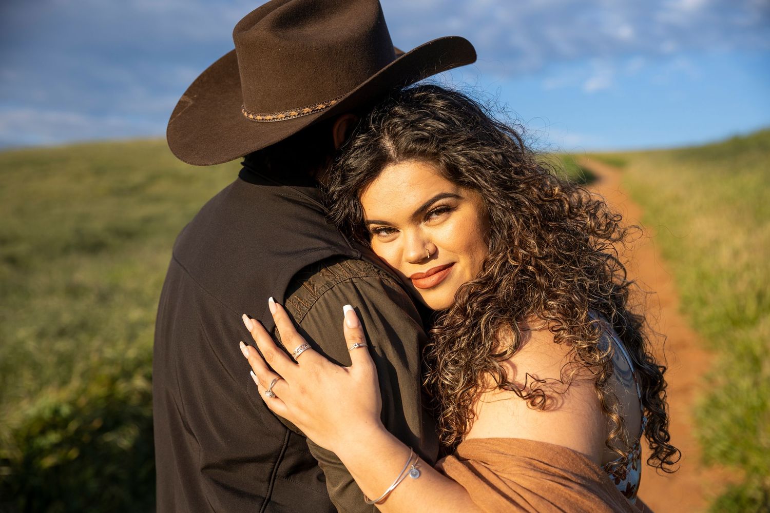 A series of outdoor portrait photos showing a person with curly hair in various poses against a natural backdrop and warm sunlight.