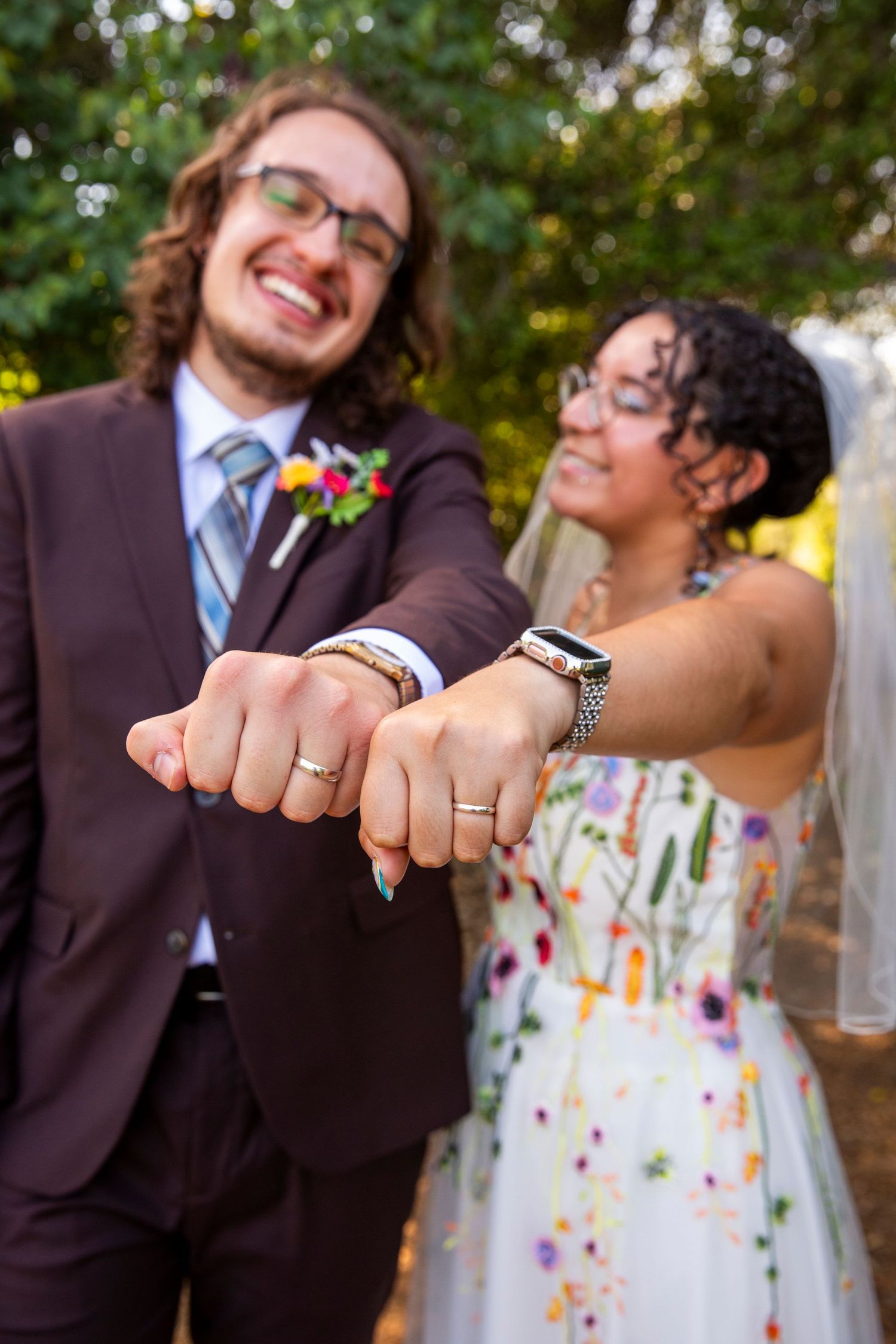 A series of progressive photos showing a celebrating couple showing their wedding rings at an outdoor celebration.