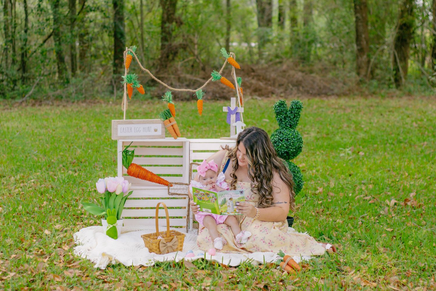 Mother arranging Easter decorations with carrots and spring props during outdoor Easter photo session.