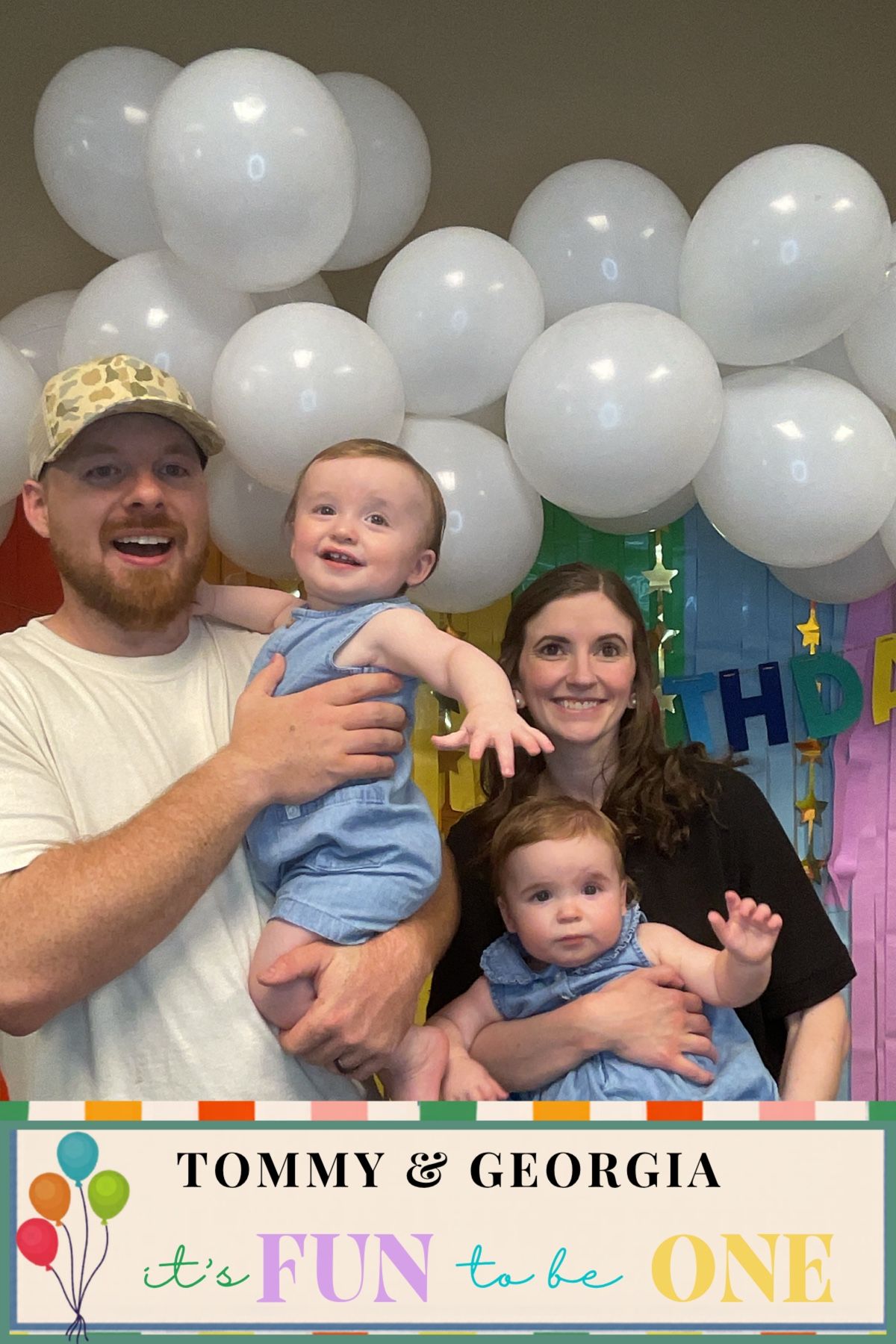 Family of four celebrating twins Tommy and Georgia's first birthday party with white balloons.