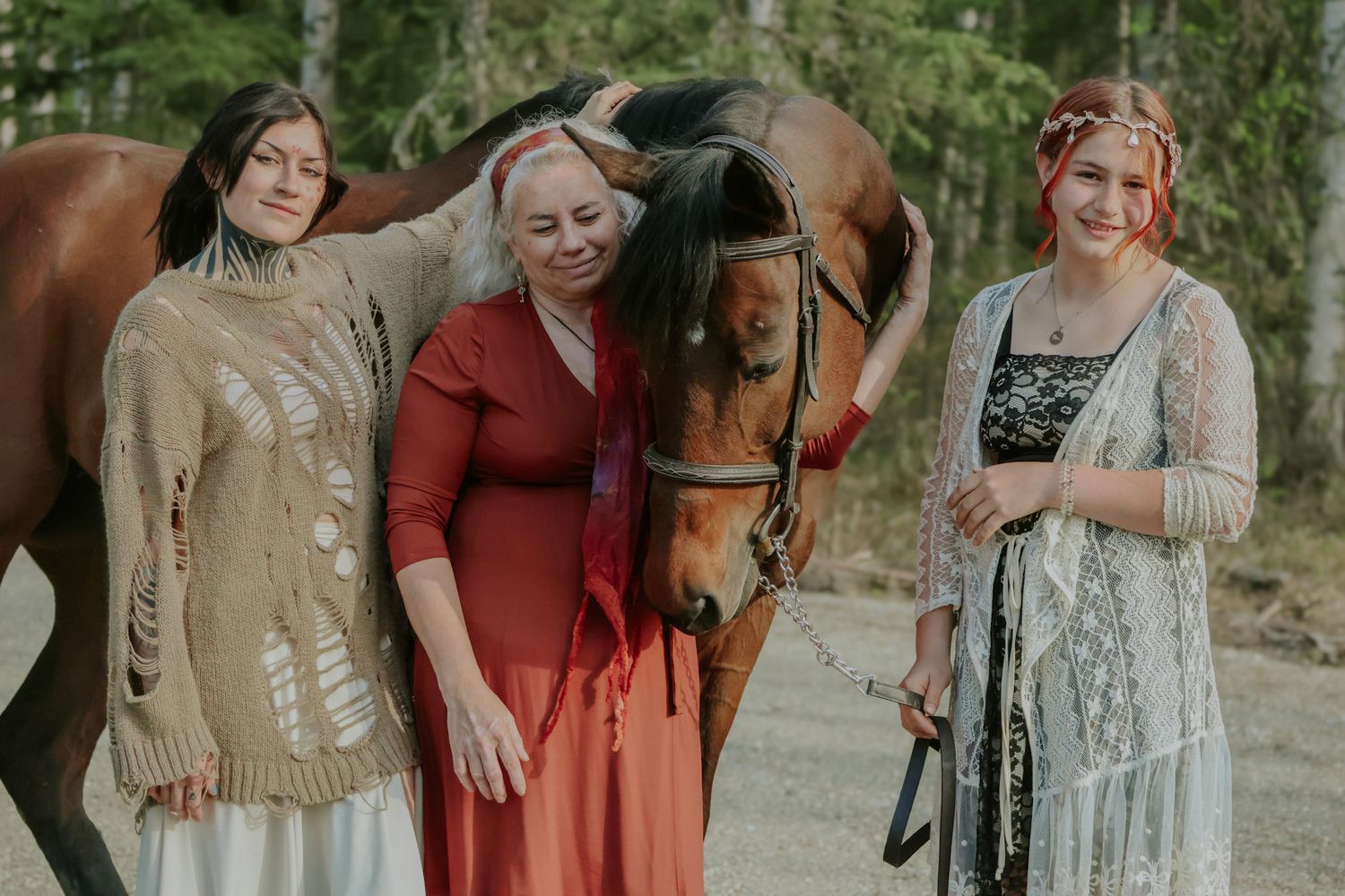 A group of people wearing coordinated fall-toned outfits pose together in a natural outdoor setting.