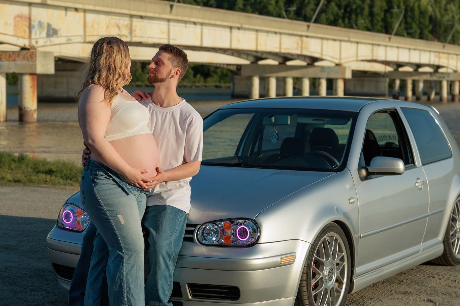 A series of romantic engagement photos showing a couple posing near a silver car at sunset.