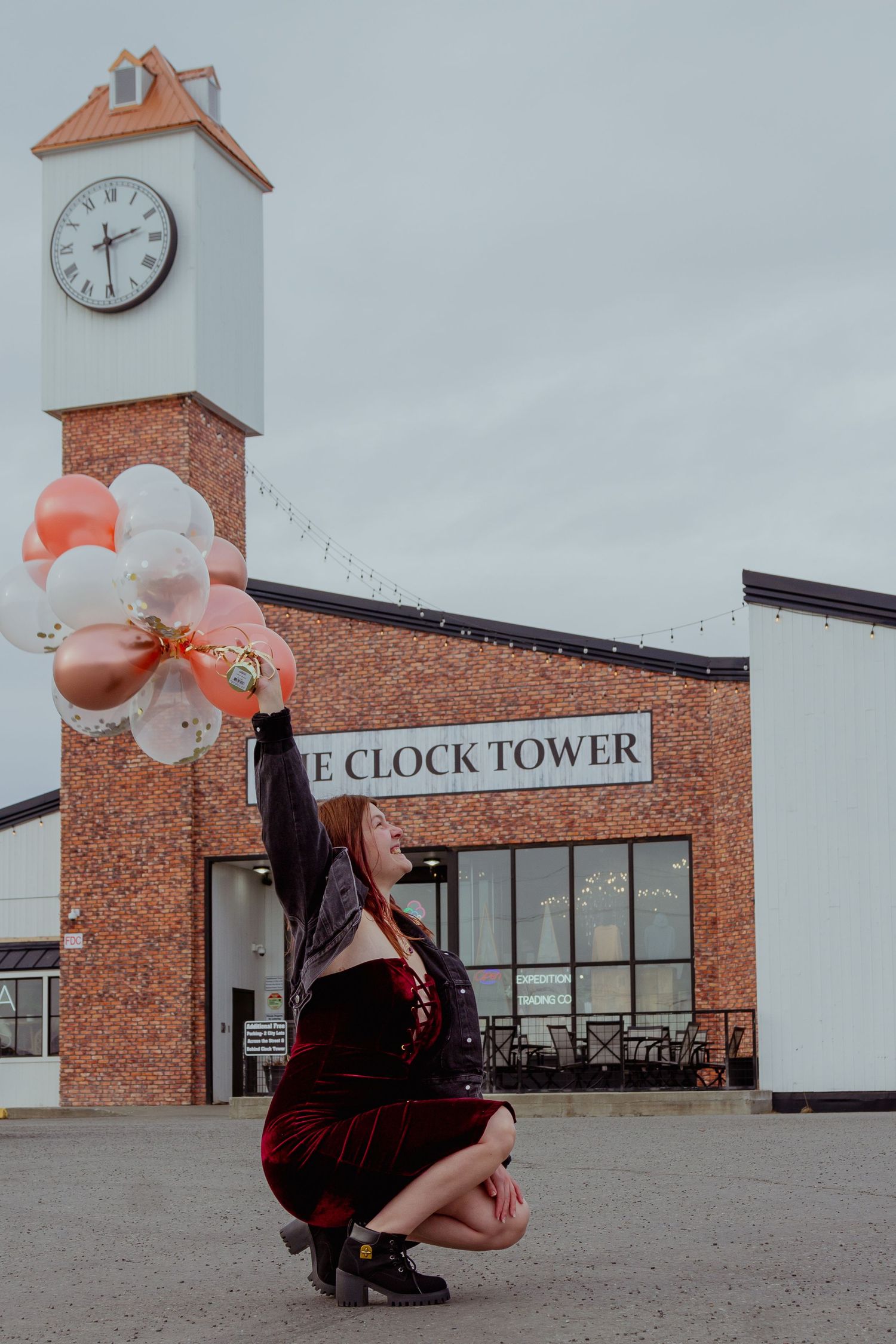 A series of four photos showing a person with balloons in front of a brick clock tower building.
