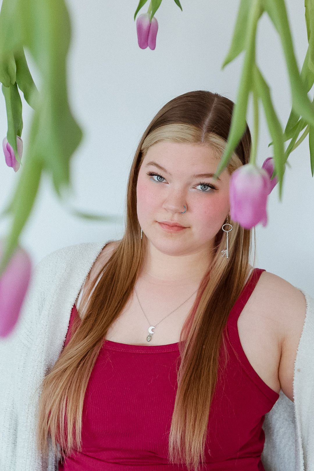 Portrait series in pink and green tones showing different poses against a floral backdrop with tulips.