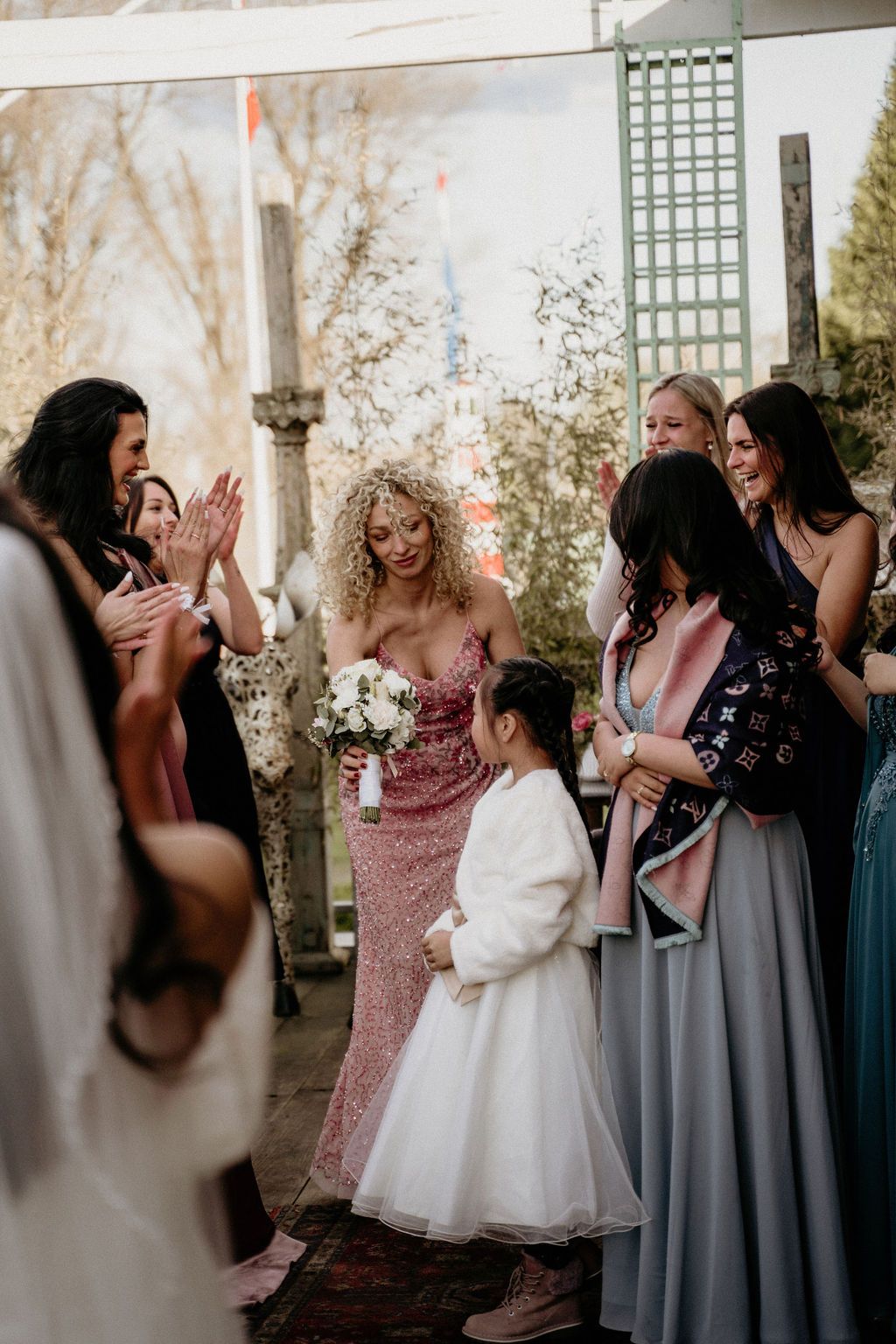 Series of photos showing a wedding party celebrating with joyful reactions at an outdoor ceremony.