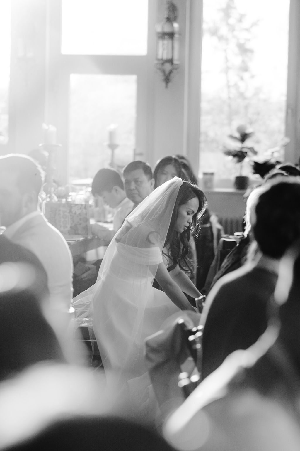Black and white photo showing a lively wedding reception crowd dancing and celebrating.
