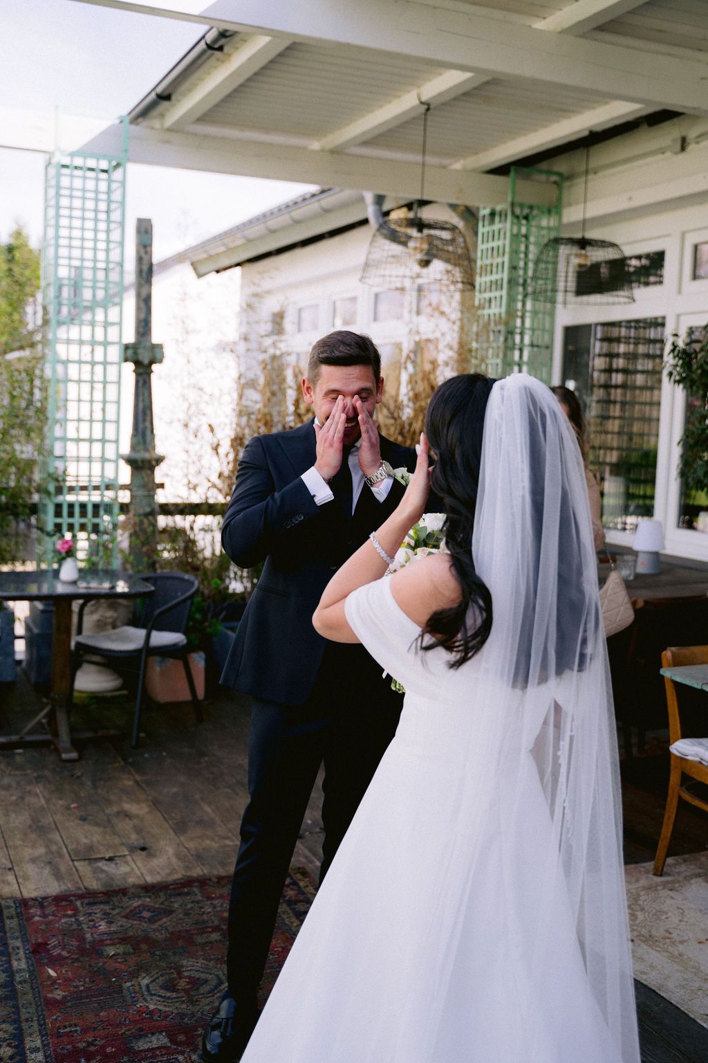 A romantic first dance sequence between newlyweds at an elegant wedding reception venue with natural lighting.