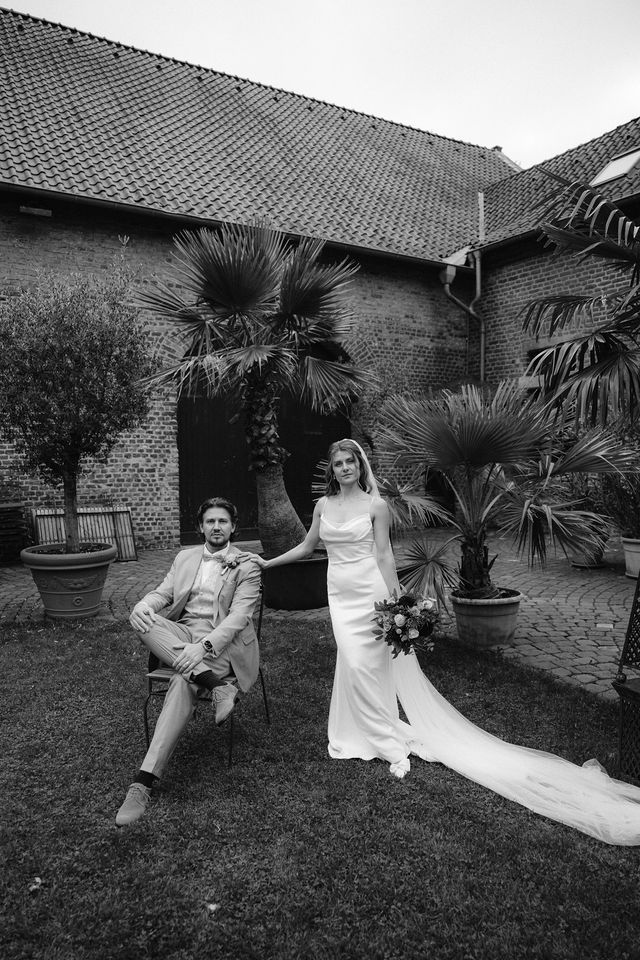 A playful black and white photo series showing a couple having fun on their wedding day in a garden setting.