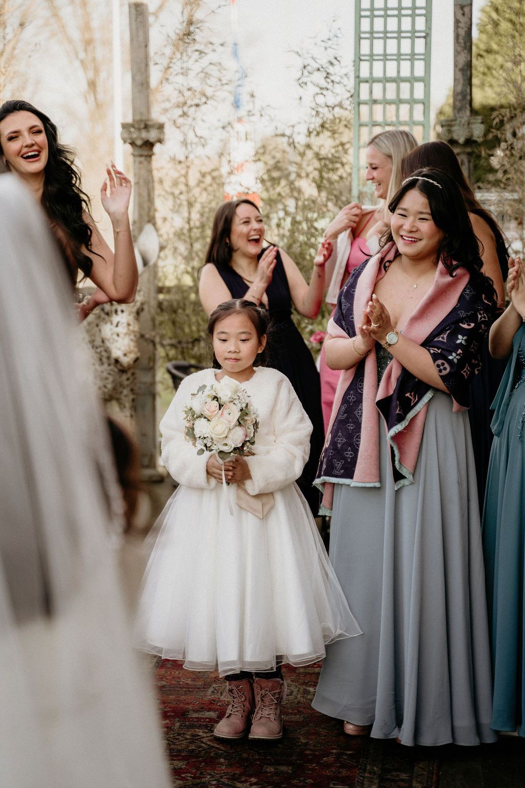A sequence of candid wedding party photos shows joyful reactions and shared laughter during a special moment.
