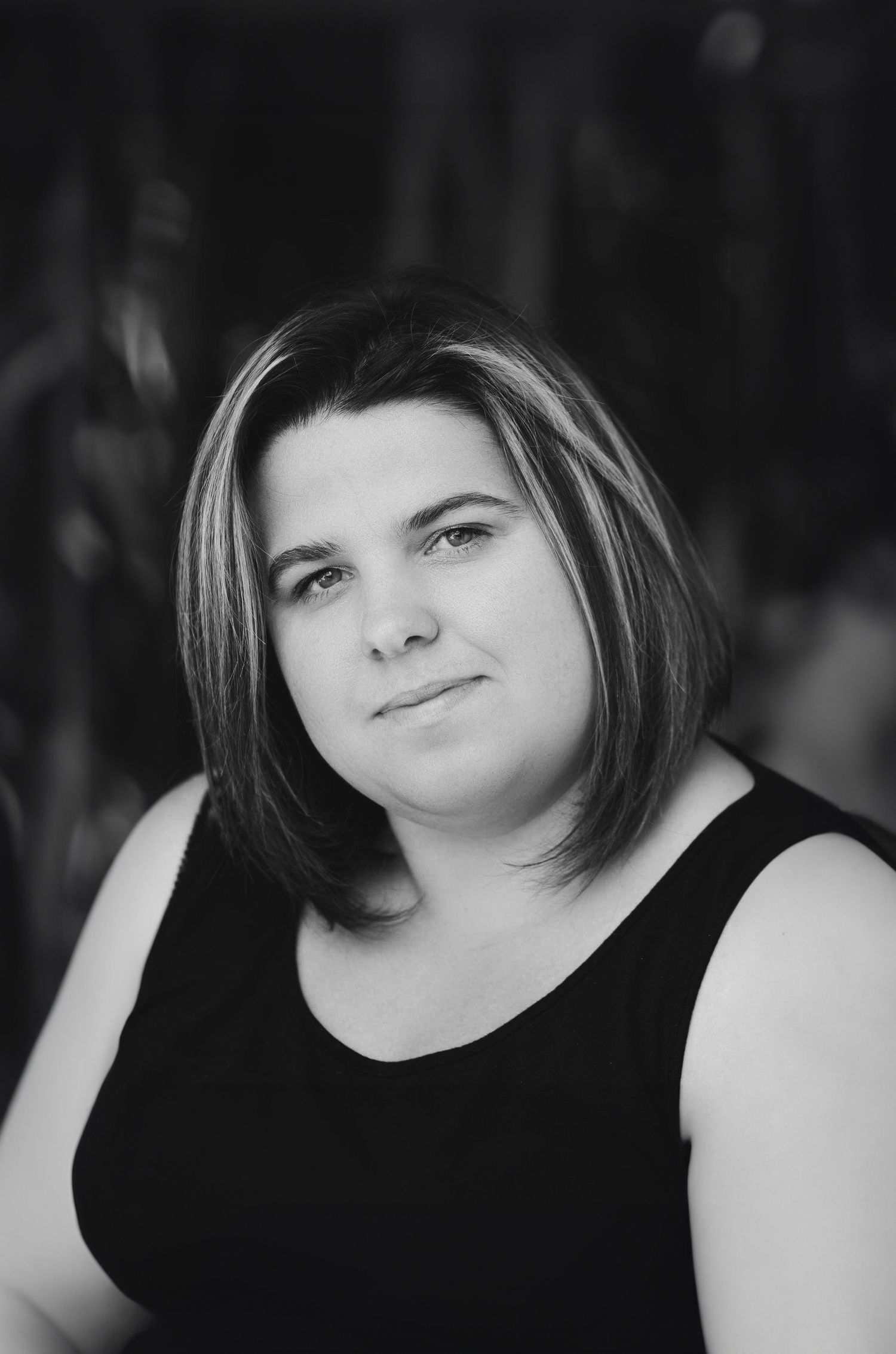 A series of four black and white portrait photos showing different emotional expressions against a dark background.