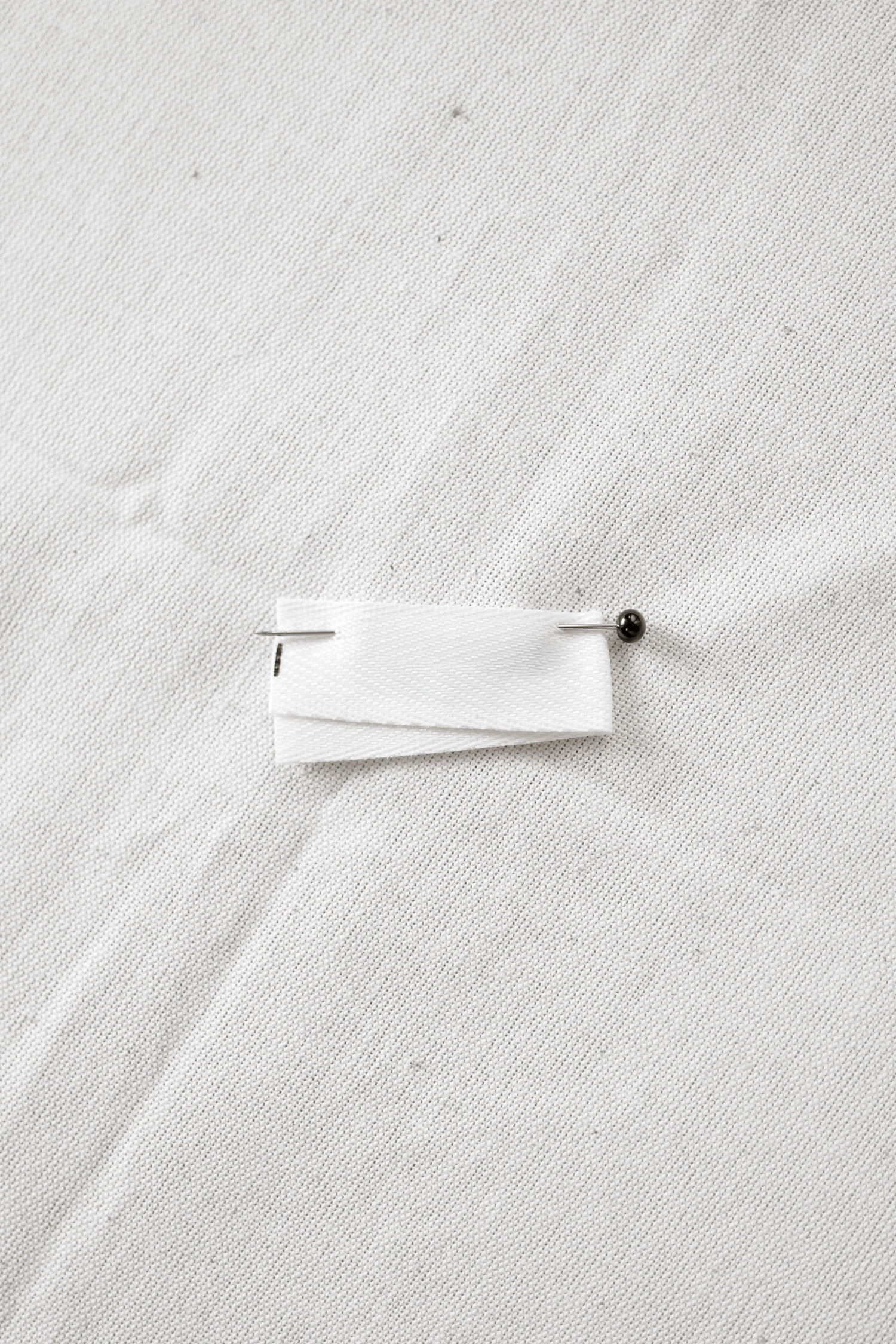 White toilet paper roll unfurling in a sequence of five progressive stages against a light background.