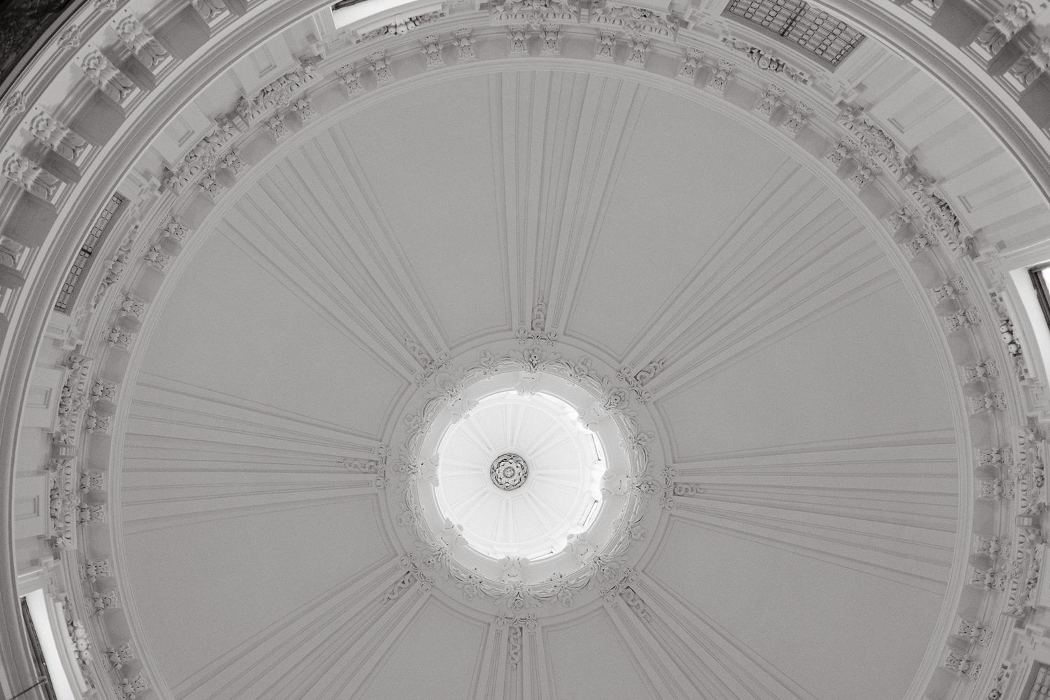 Ornate neoclassical domed ceiling with intricate architectural details and decorative moldings radiating from center.