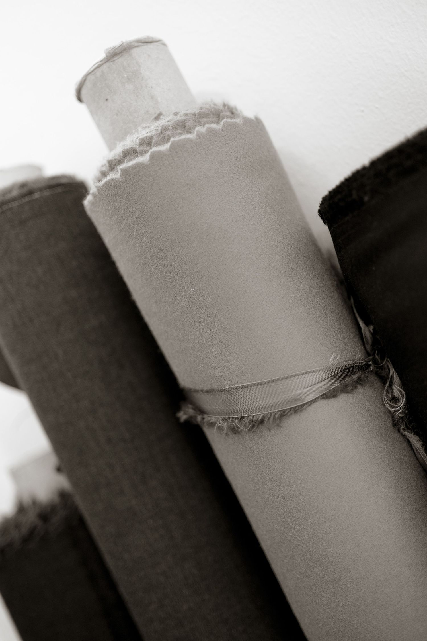 A black and white artistic photograph showing contrasting light and dark cylindrical shapes in close-up detail.