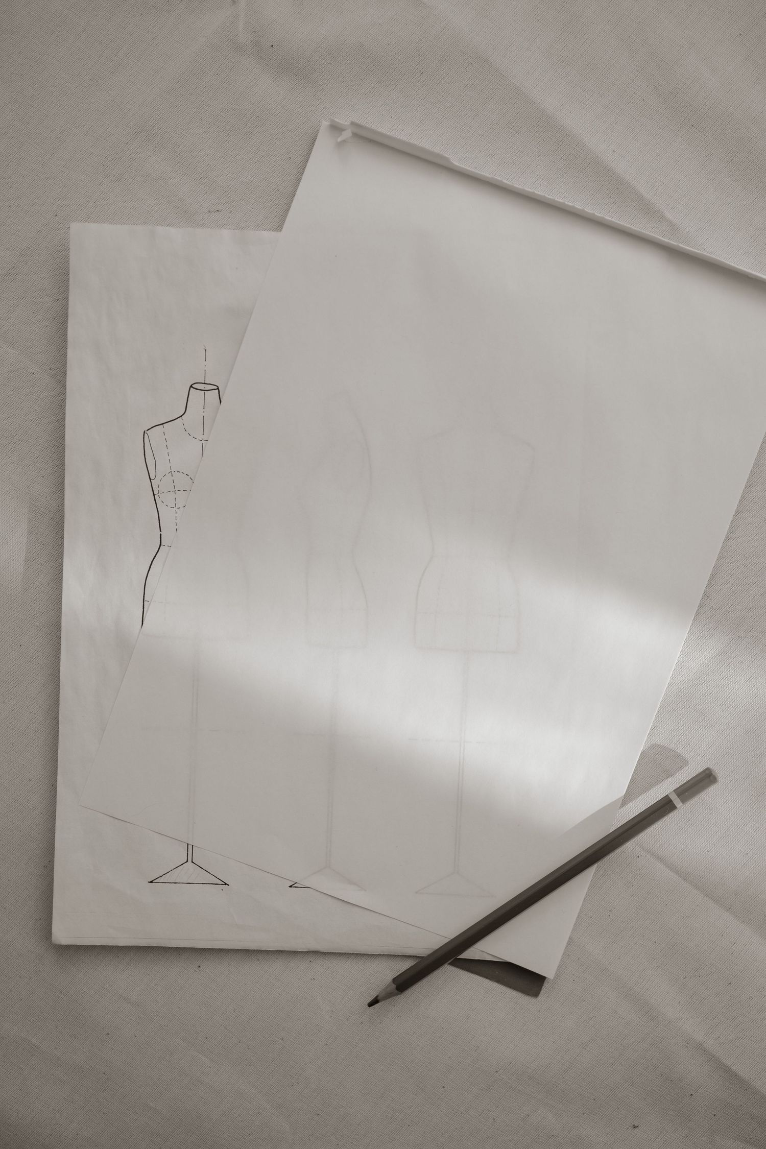 A series of minimalist line drawings on white paper showing simple geometric shapes and lines with a pencil.