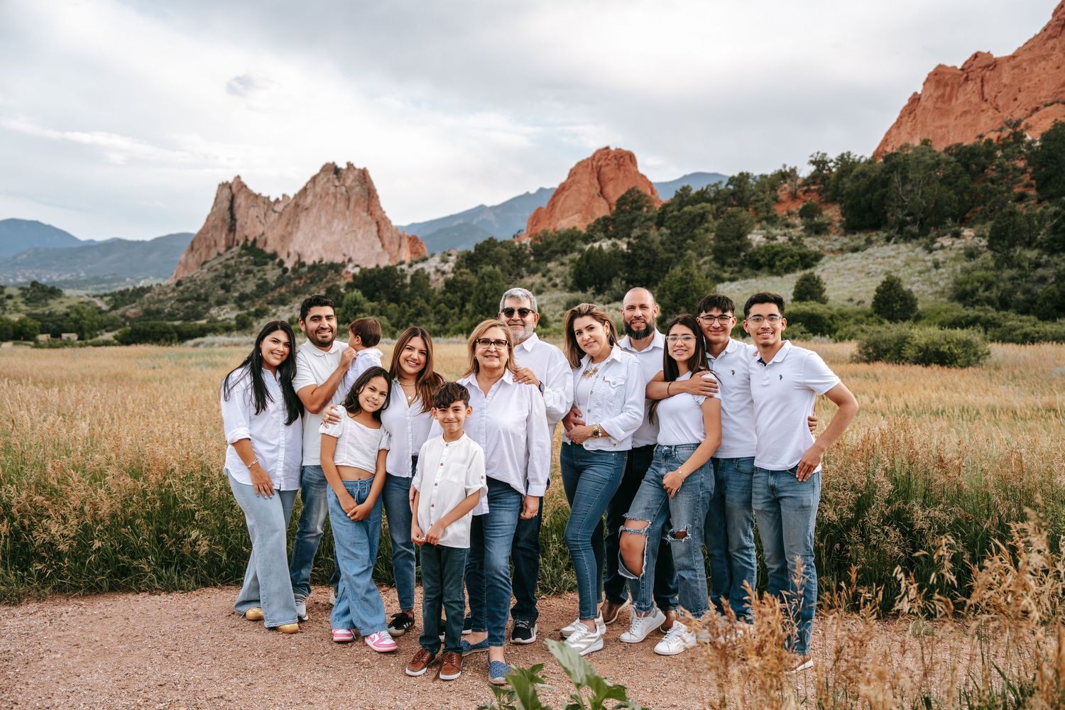 Large family group photo in white shirts and jeans at Garden of the Gods Colorado.