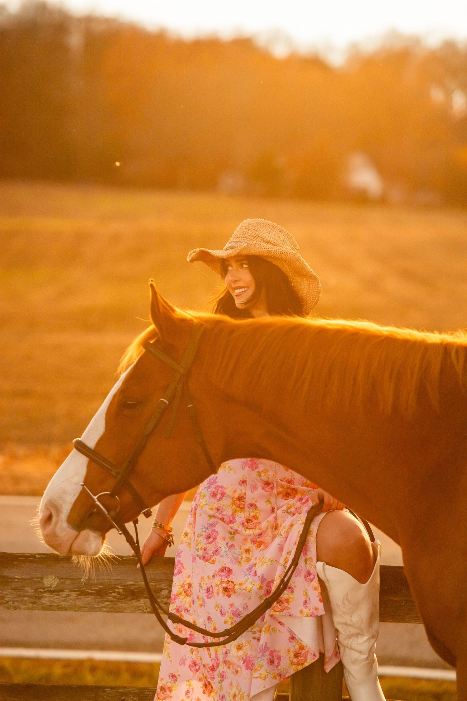Horse and companion enjoying sunset moment with floral dress and western boots.