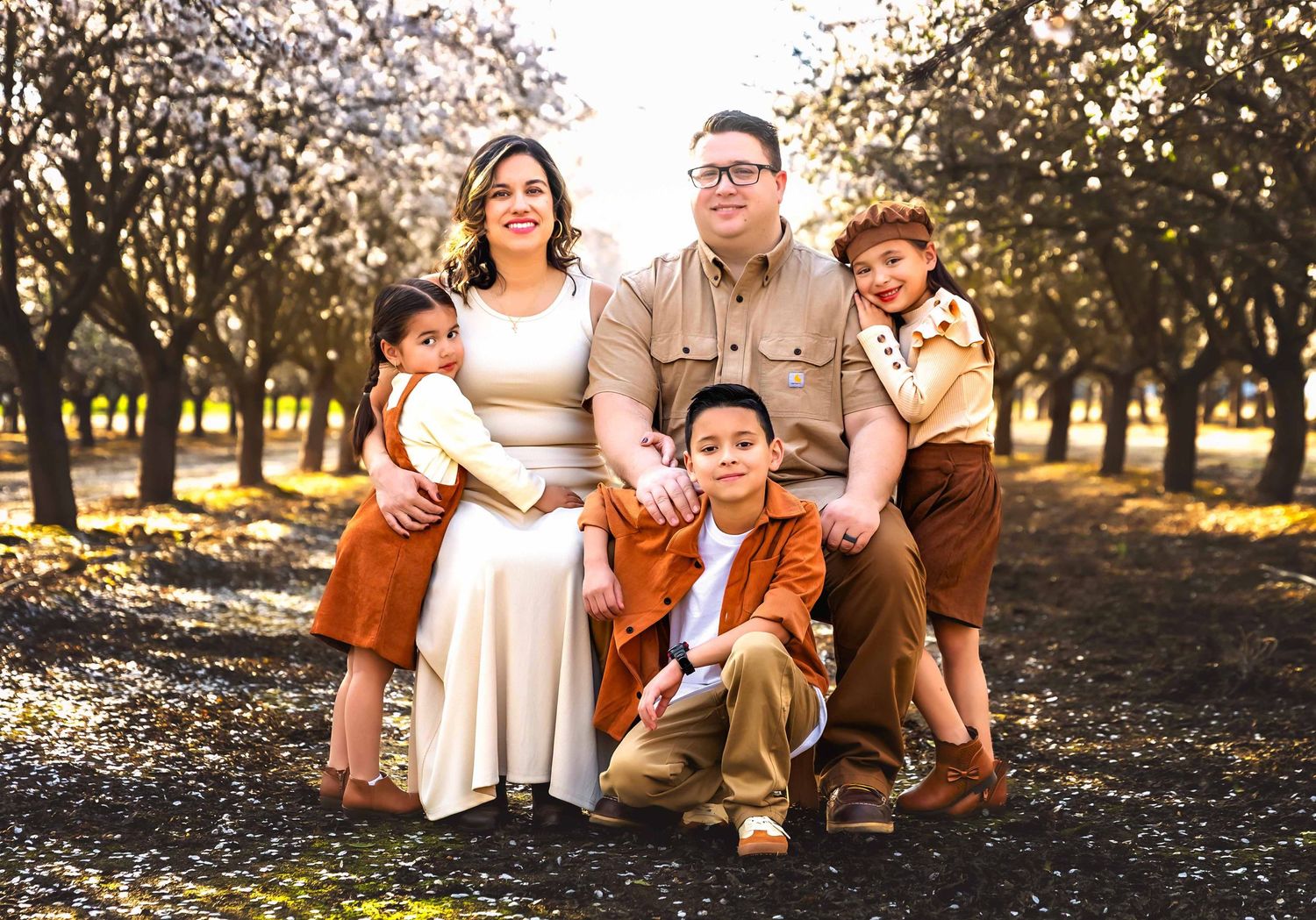 Fresno family photographer Colibri Captures outdoor family session in the local almond blossoms.