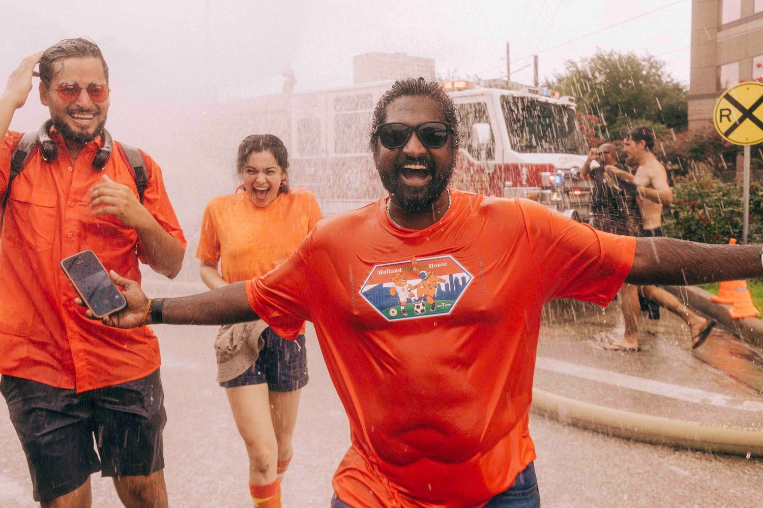FIFA World Cup 2026 Houston | participants enjoy the firehose from HFD during the Orange Bus fan walk | Photos by Robert Paul
