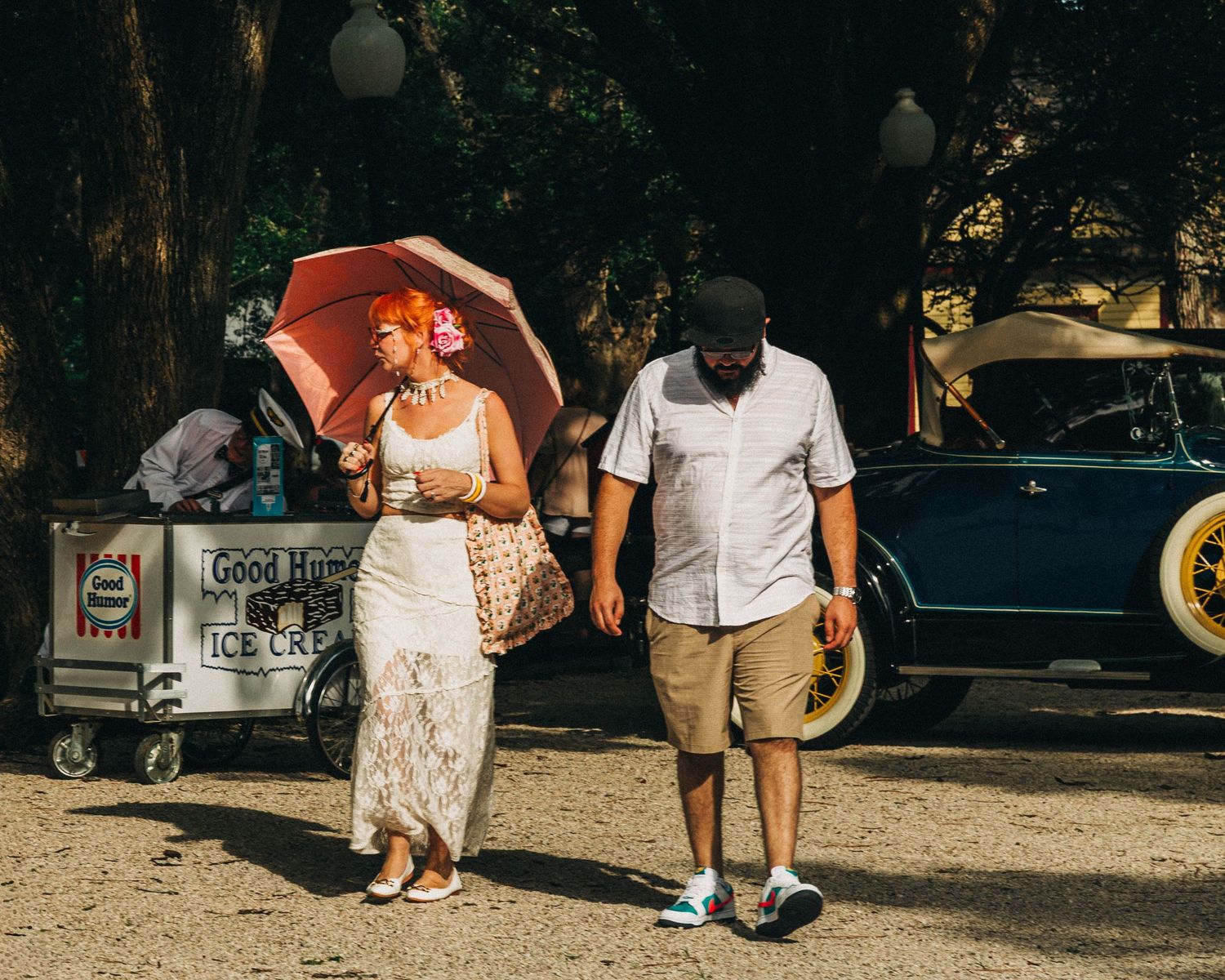Street photography by Robert Paul | umbrella couple White Linen Festival in League City, Texas, 2025
