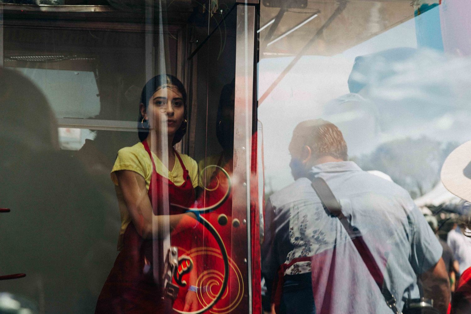 Street photography by Robert Paul | woman food vendor leans for a break at Bigass Crawfish Bash Texas City 2026