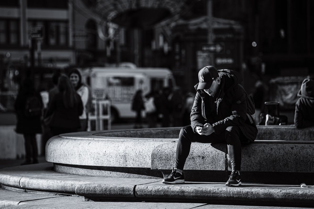 Street photography by Robert Paul | Columbus Circle Central Park man sits in thought New York City