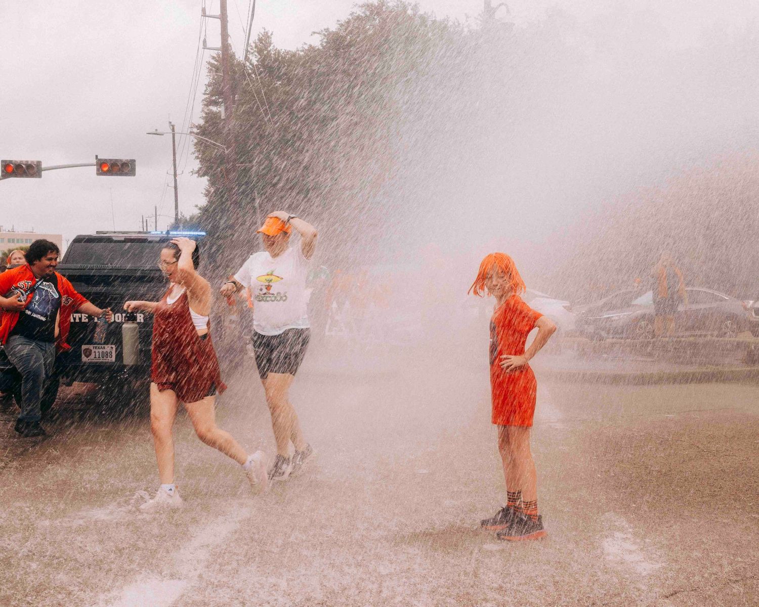 FIFA World Cup 2026 Houston | Young fan cools off in during the Houston heat during Orange Bus fan walk | Photos by Robert Paul