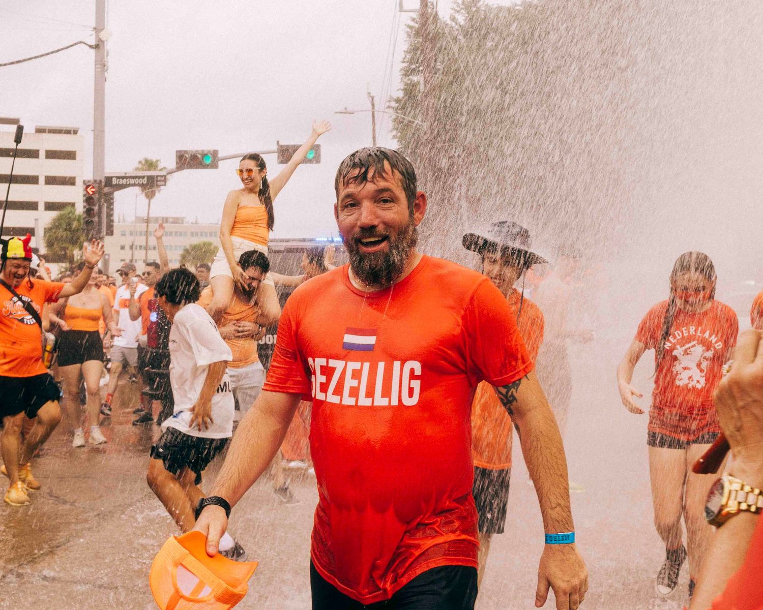 FIFA World Cup 2026 Houston | Netherland's football fan cools off from a firehose from HFD Orange Bus fan walk | Photos by Robert Paul