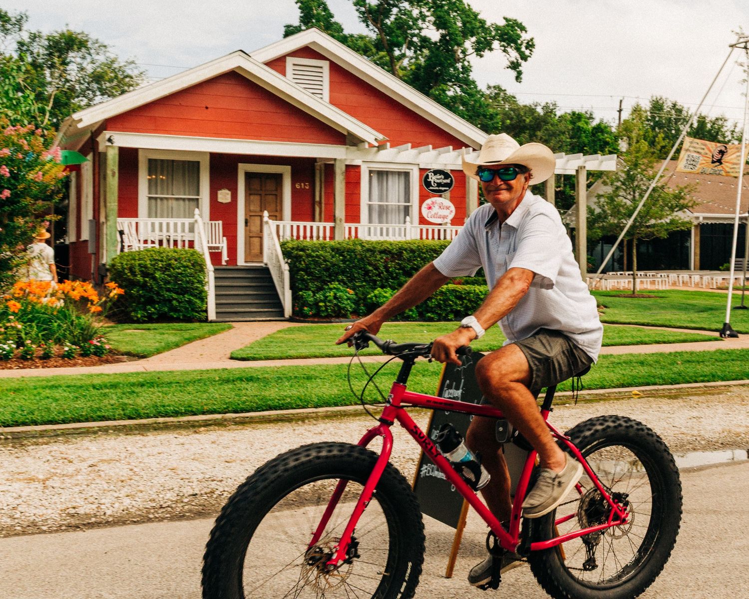Street photography by Robert Paul | Man on bicycle White Linen Festival in League City, Texas, 2025