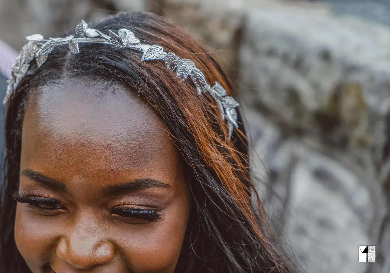 Close-up of bride wearing elegant silver leaf bridal headpiece on her wedding day.
