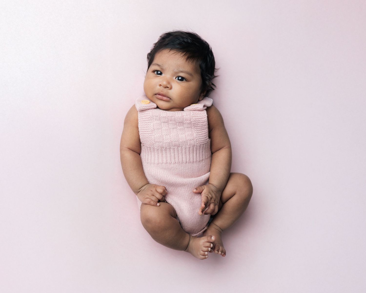 Pink background and pink newborn outfit