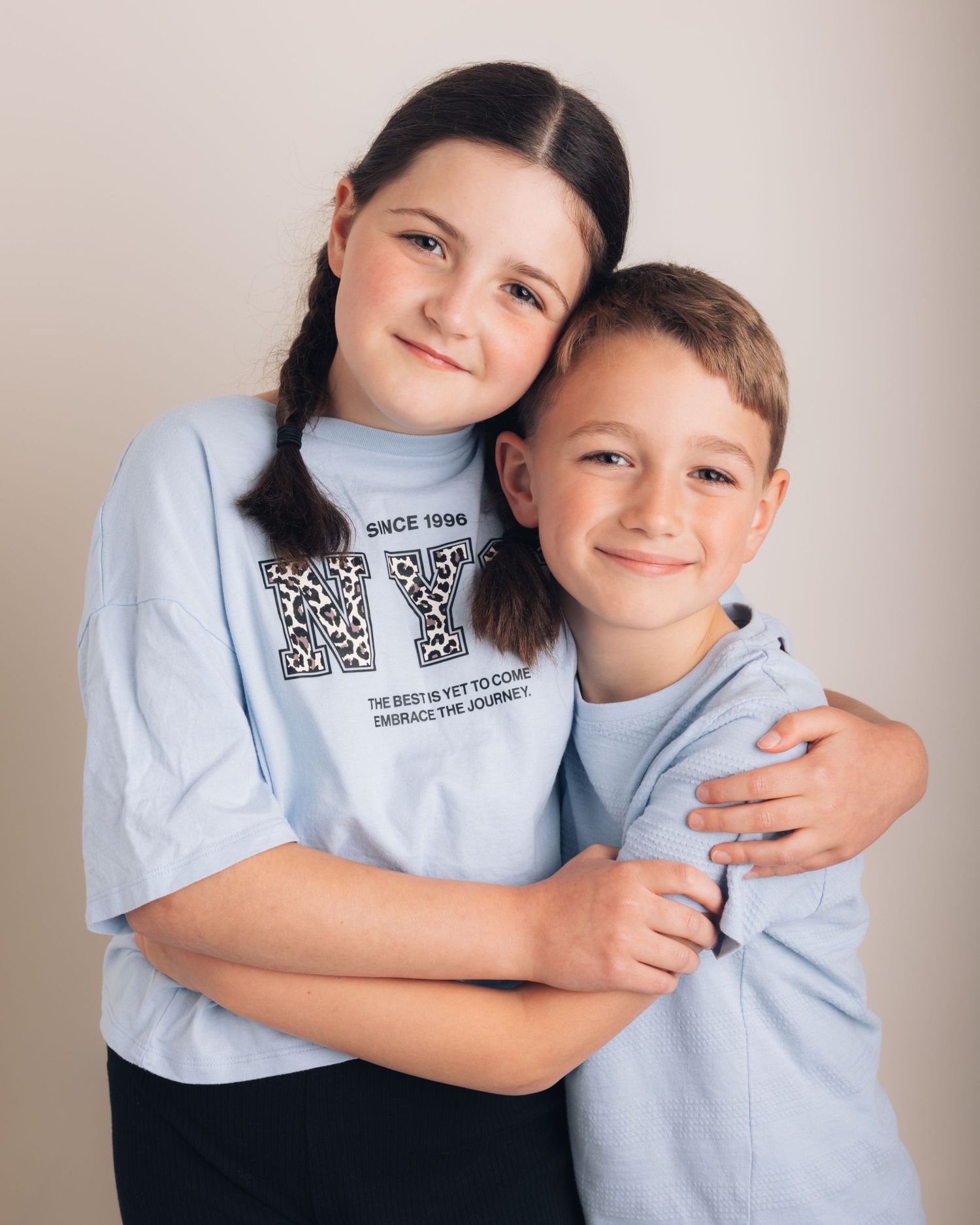 Children, siblings cuddling for a photoshoot