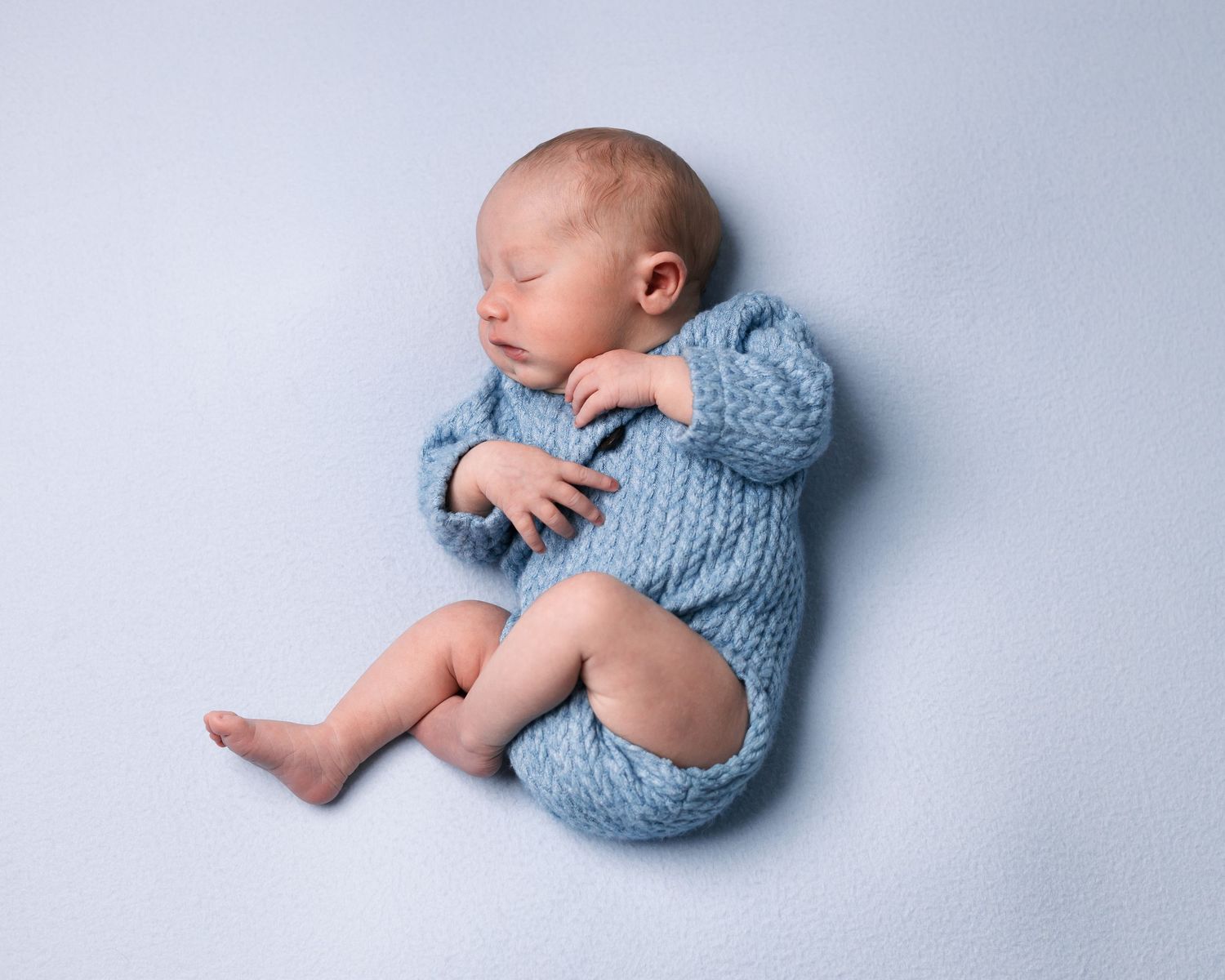Blue background and blue newborn outfit