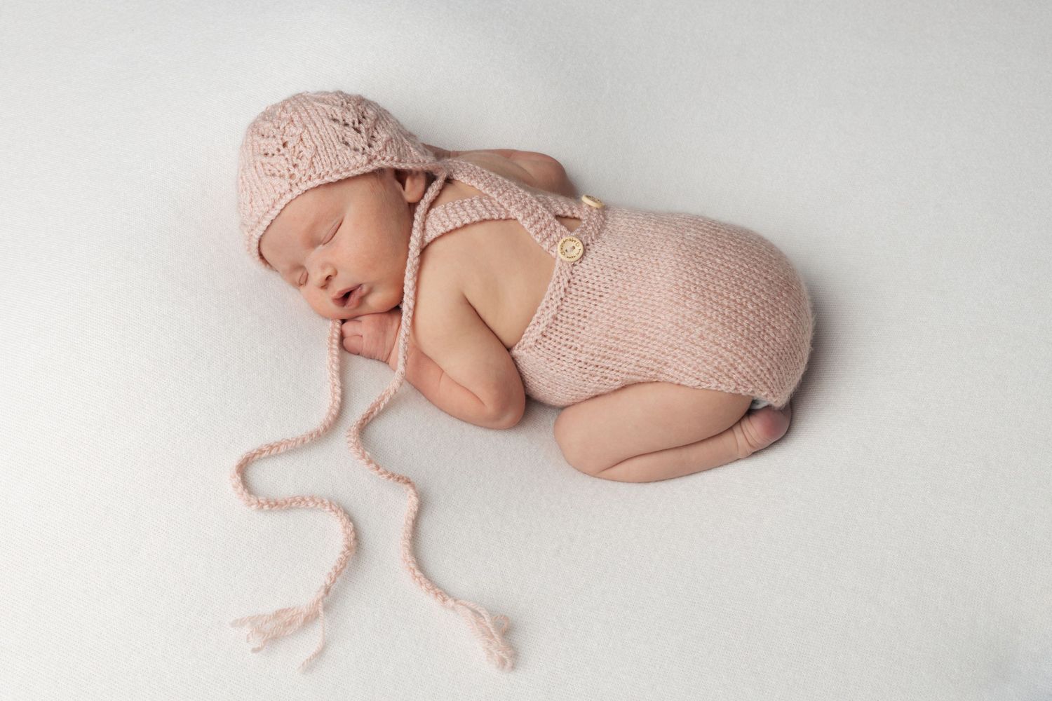 Baby with outfit and matching bonnet hat