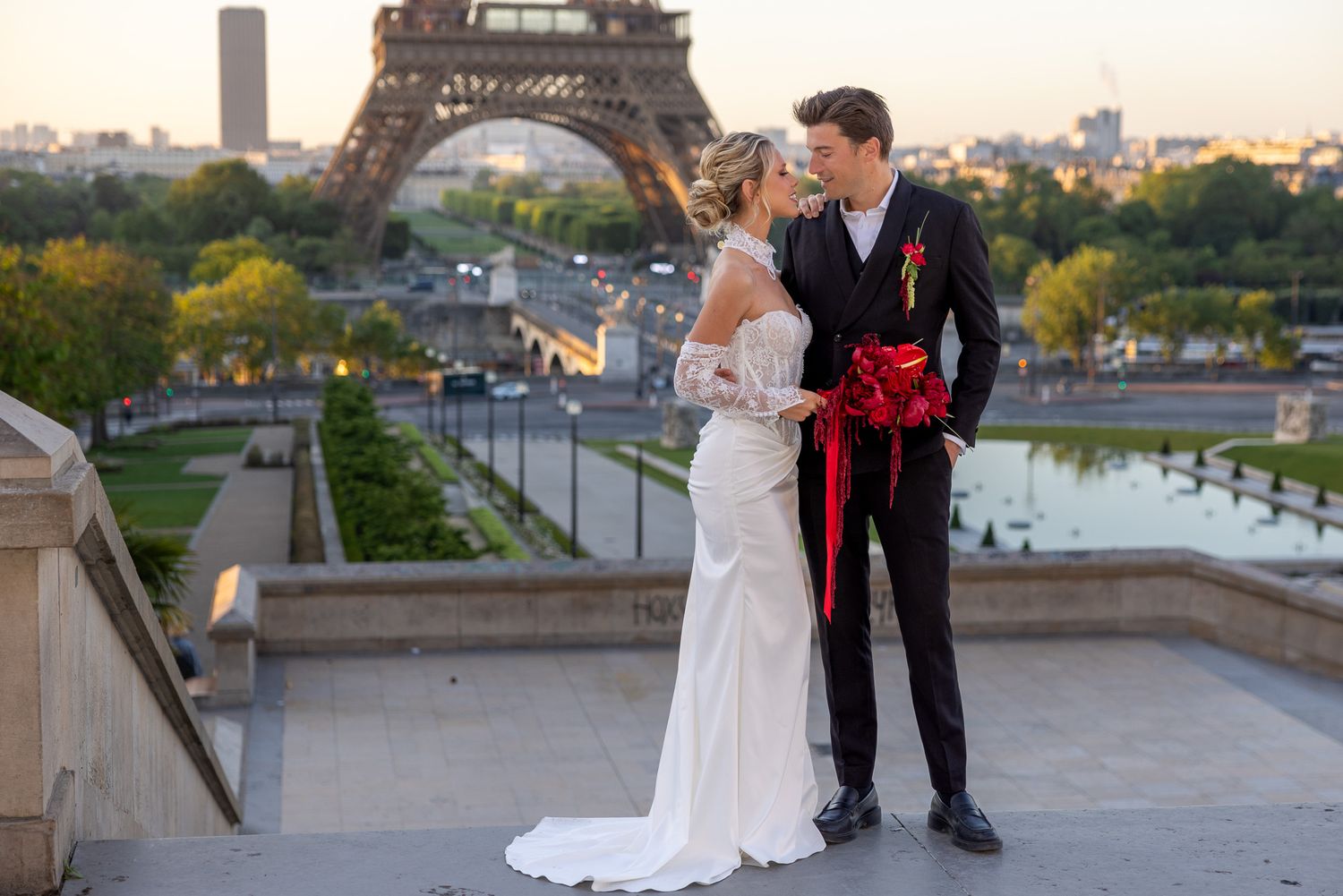 Bride and groom share a romantic moment with the Eiffel Tower backdrop at sunset in Paris.