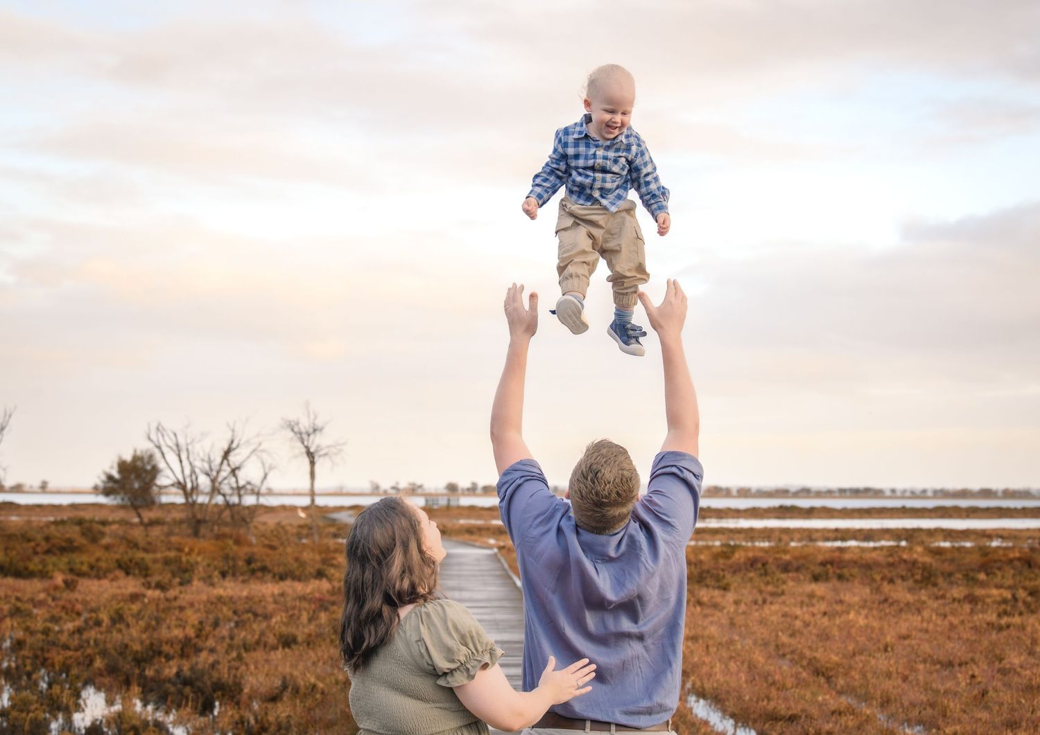 Candid family photo of kids playing and laughing during a portrait session.