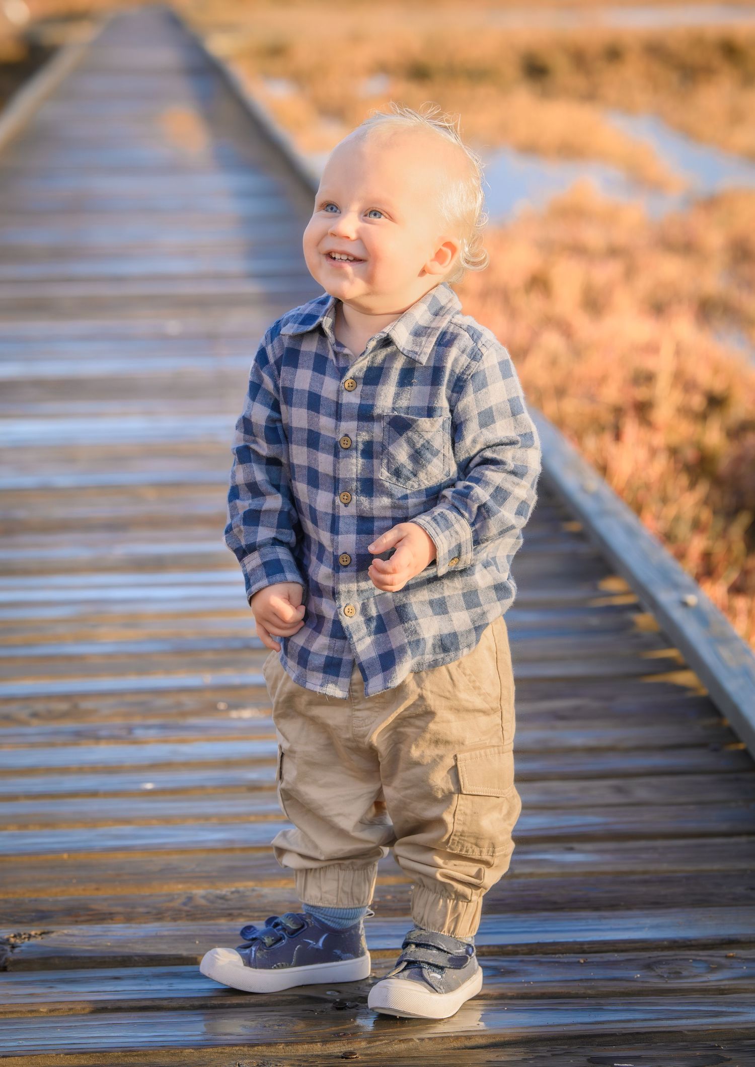 Candid family photo of kids playing and laughing during a portrait session.