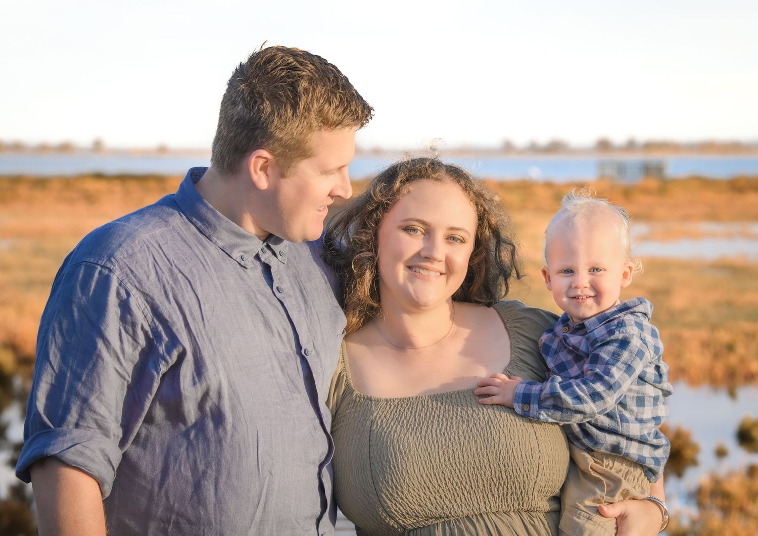 Candid family photo of kids playing and laughing during a portrait session.