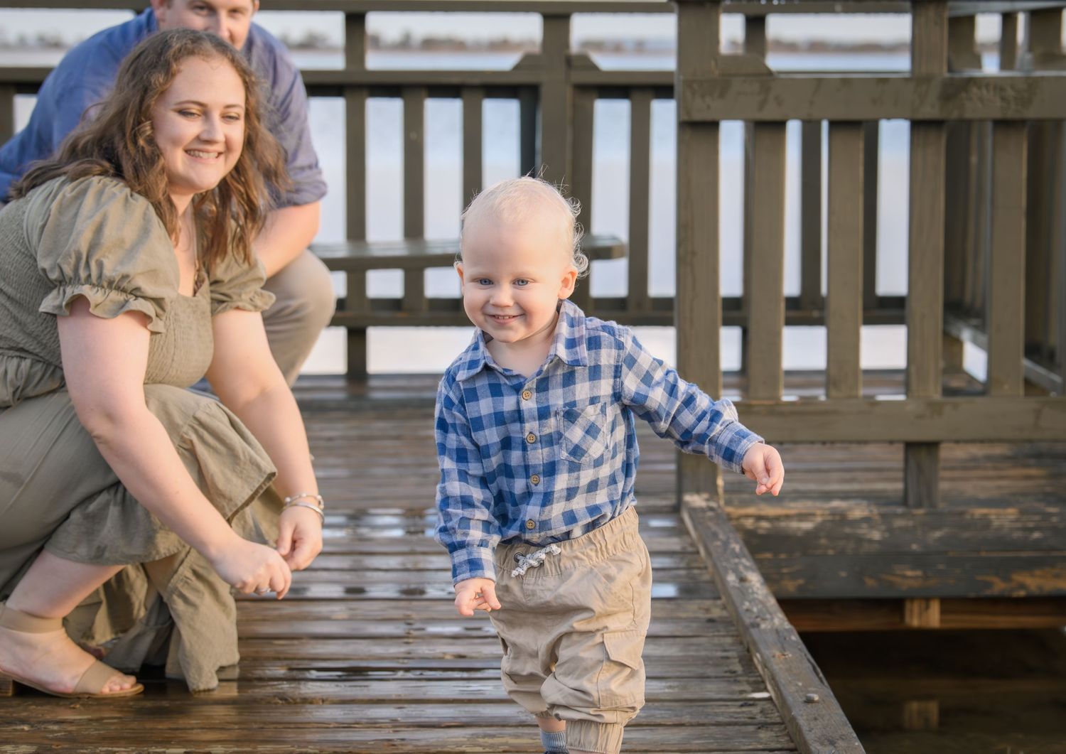 Candid family photo of kids playing and laughing during a portrait session.