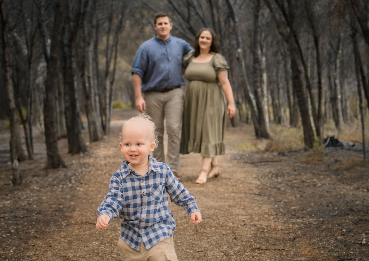 Candid family photo of kids playing and laughing during a portrait session.