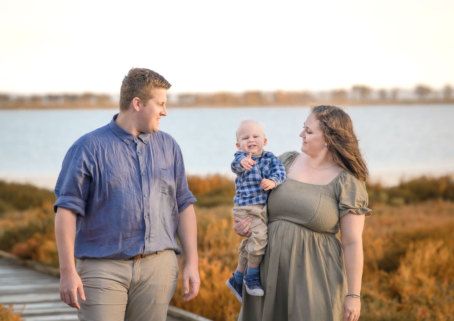 Candid family photo of kids playing and laughing during a portrait session.